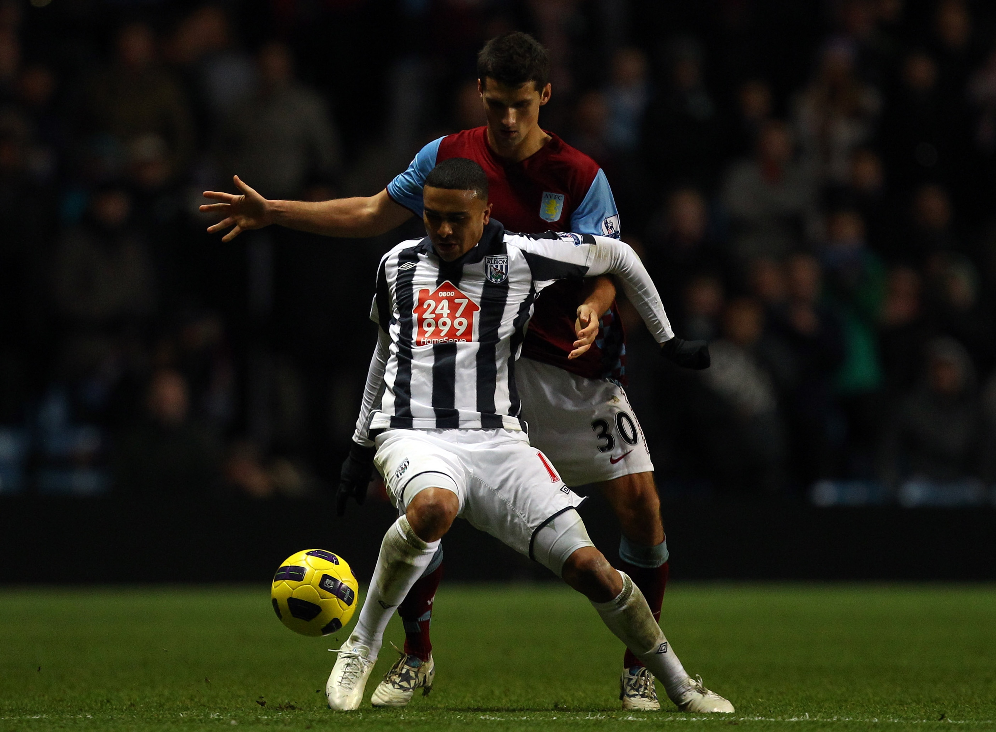 BIRMINGHAM, ENGLAND - DECEMBER 11:  Jerome Thomas of West Brom battles with Eric Lichaj of Villa during the Barclays Premier League match between Aston Villa and West Bromwich Albion at Villa Park on December 11, 2010 in Birmingham, England.  (Photo by Ri
