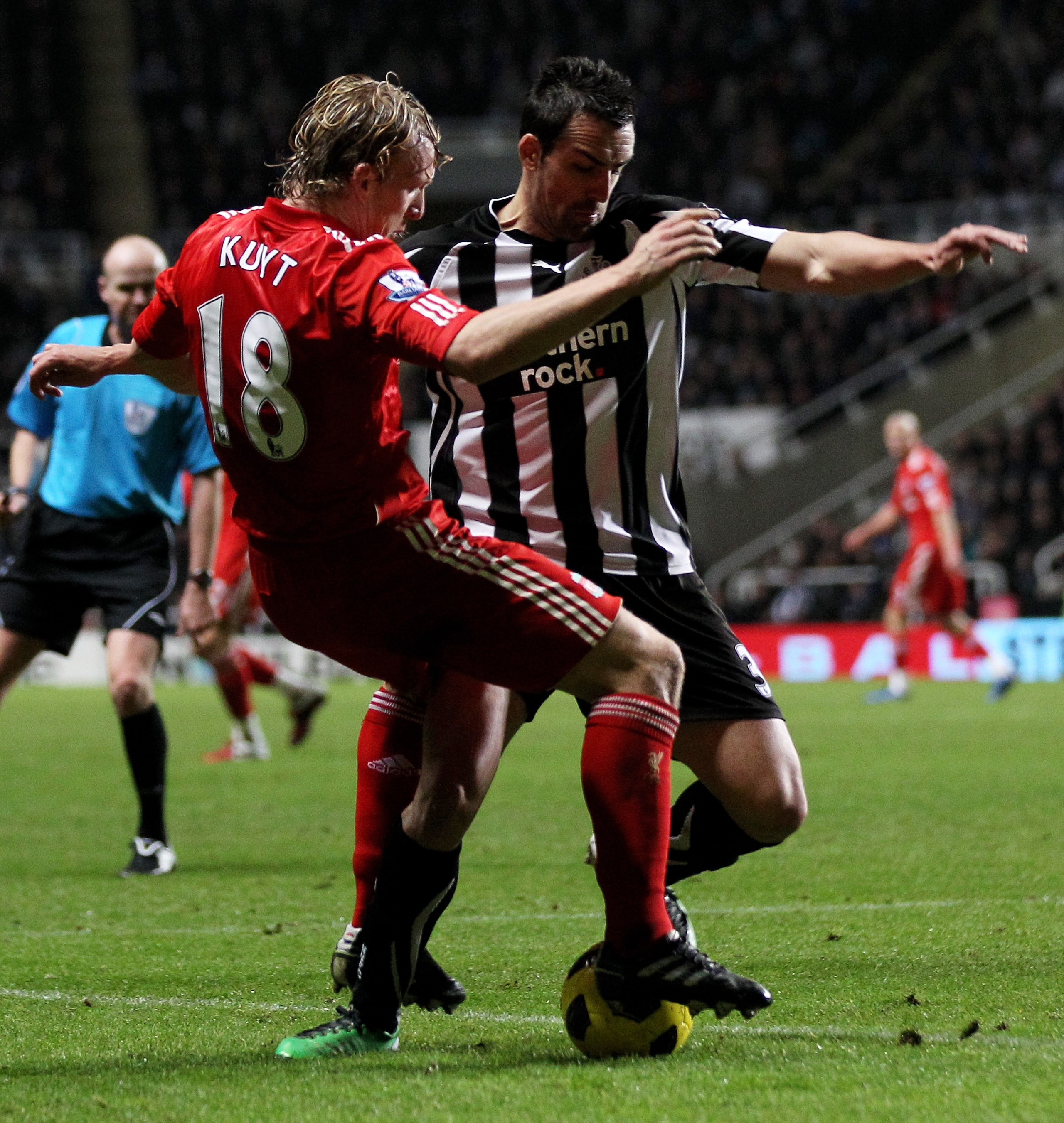 NEWCASTLE UPON TYNE, ENGLAND - DECEMBER 11:  Dirk Kuyt of Liverpool tangles with Jose Enrique of Newcastle United during the Barclays Premier League match between Newcastle United and Liverpool at St James' Park on December 11, 2010 in Newcastle, England.