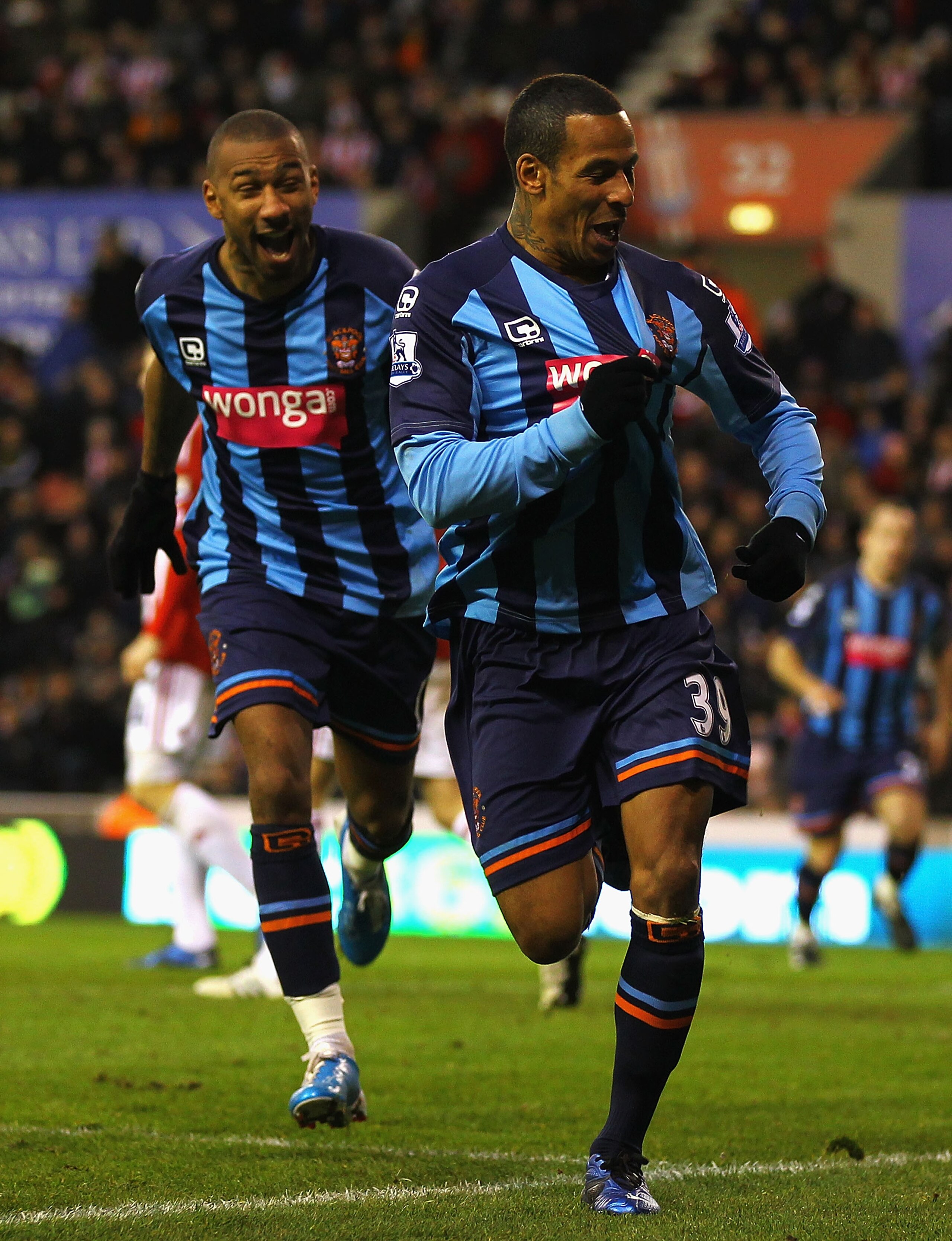 STOKE ON TRENT, ENGLAND - DECEMBER 11:  DJ Campbell of Blackpool celebrates his goal during the Barclays Premier League match between Stoke City and Blackpool at Britannia Stadium on December 11, 2010 in Stoke on Trent, England.  (Photo by Matthew Lewis/G