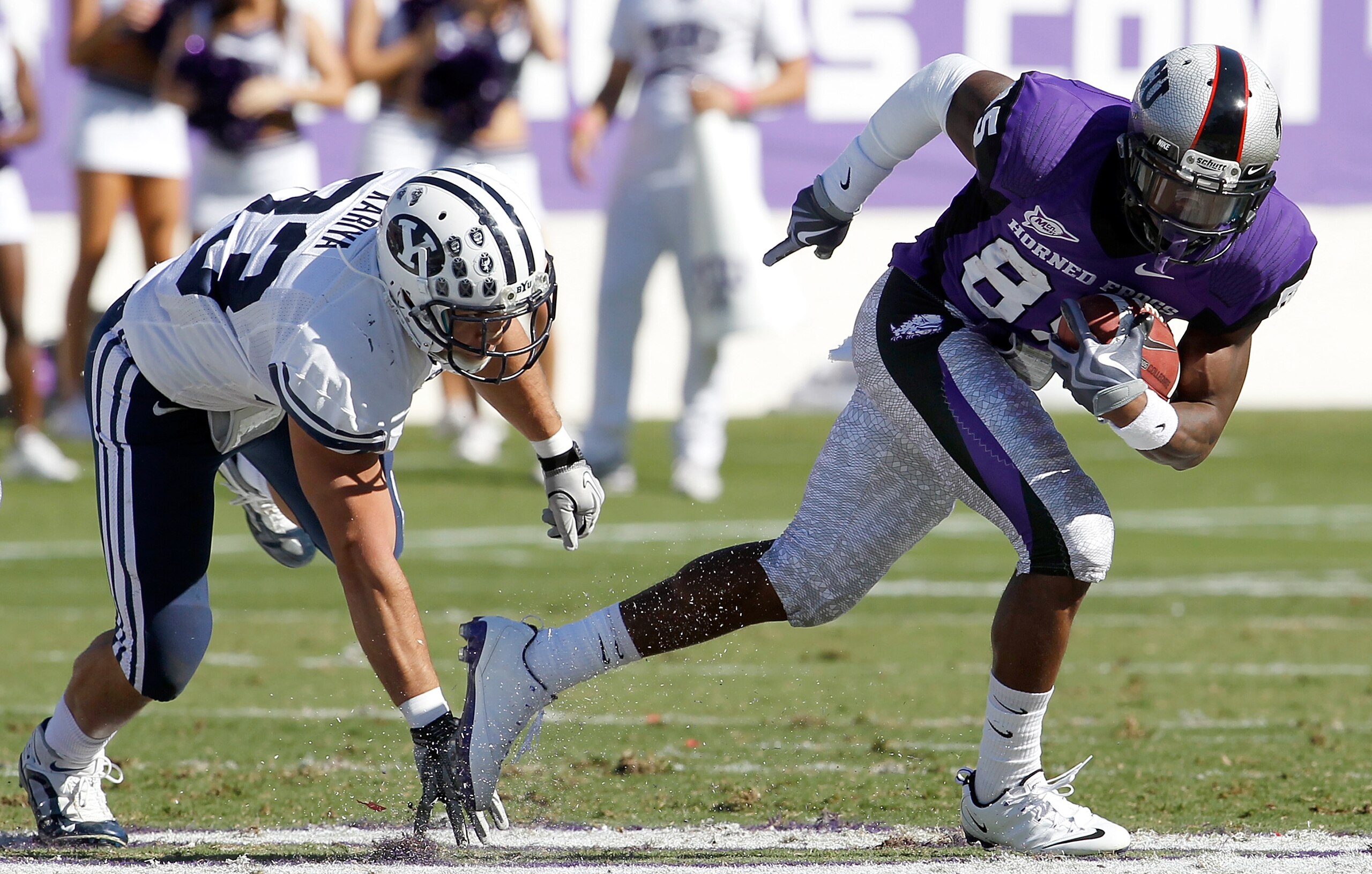 FORT WORTH, TX - OCTOBER 16:  Wide receiver Jeremy Kerley #85 of the TCU Horned Frogs carries the ball against defensice back Bryan Kariya #33 of the BYU Cougars at Amon G. Carter Stadium on October 16, 2010 in Fort Worth, Texas.  TCU beat BYU 31-3.  (Pho