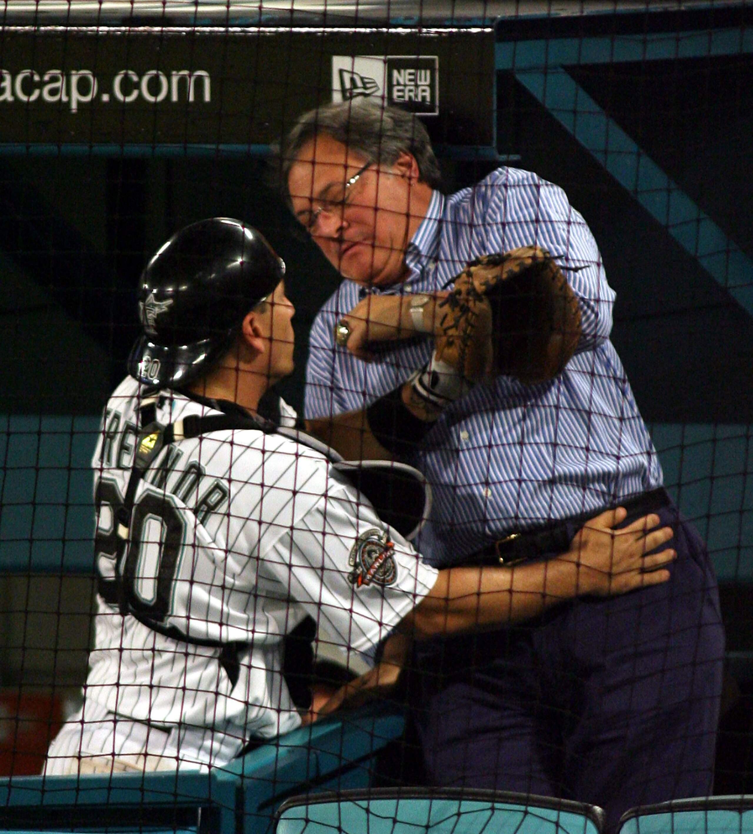 MIAMI - AUGUST 17: Catcher Matt Treanor #20 of the Florida Marlins crashes into team owner Jeffrey Loria in the fifth inning while playing against the San Francisco Giants at Dolphin Stadium on August 17, 2007 in Miami, Florida.  (Photo by Marc Serota/Get