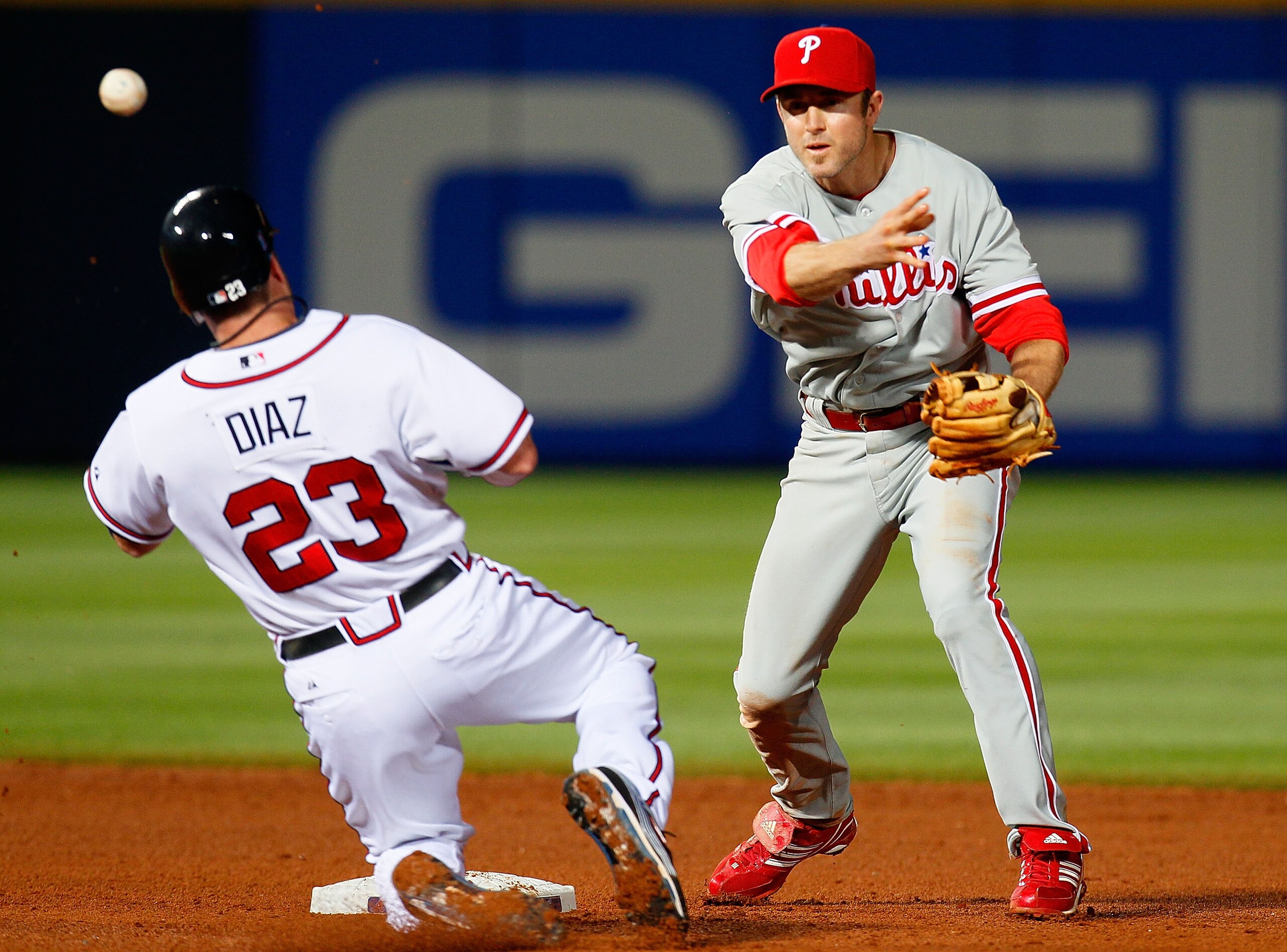 ATLANTA - APRIL 22:  Chase Utley #26 of the Philiadelphia Phillies attempts to turn a double play over Matt Diaz #23 of the Atlanta Braves at Turner Field on April 22, 2010 in Atlanta, Georgia.  (Photo by Kevin C. Cox/Getty Images)