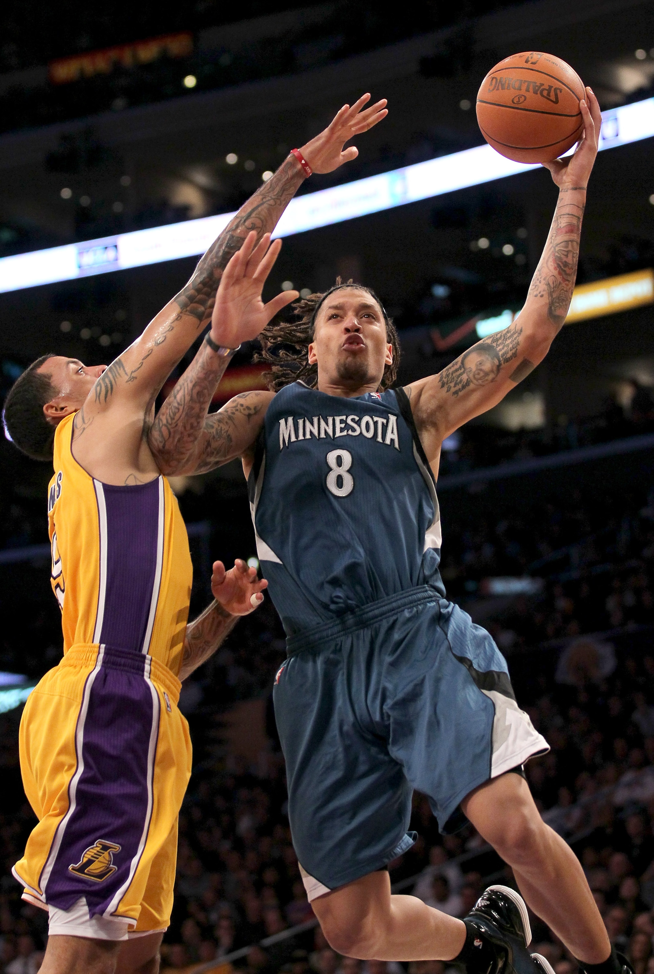LOS ANGELES - NOVEMBER 9: Michael Beasley #8 of the Minnesota Timberwolves goes up for a shot against Matt Barnes #9 of the Los Angeles Lakers at Staples Center on November 9, 2010 in Los Angeles, California. The Lakers won 99-94.   NOTE TO USER: User exp