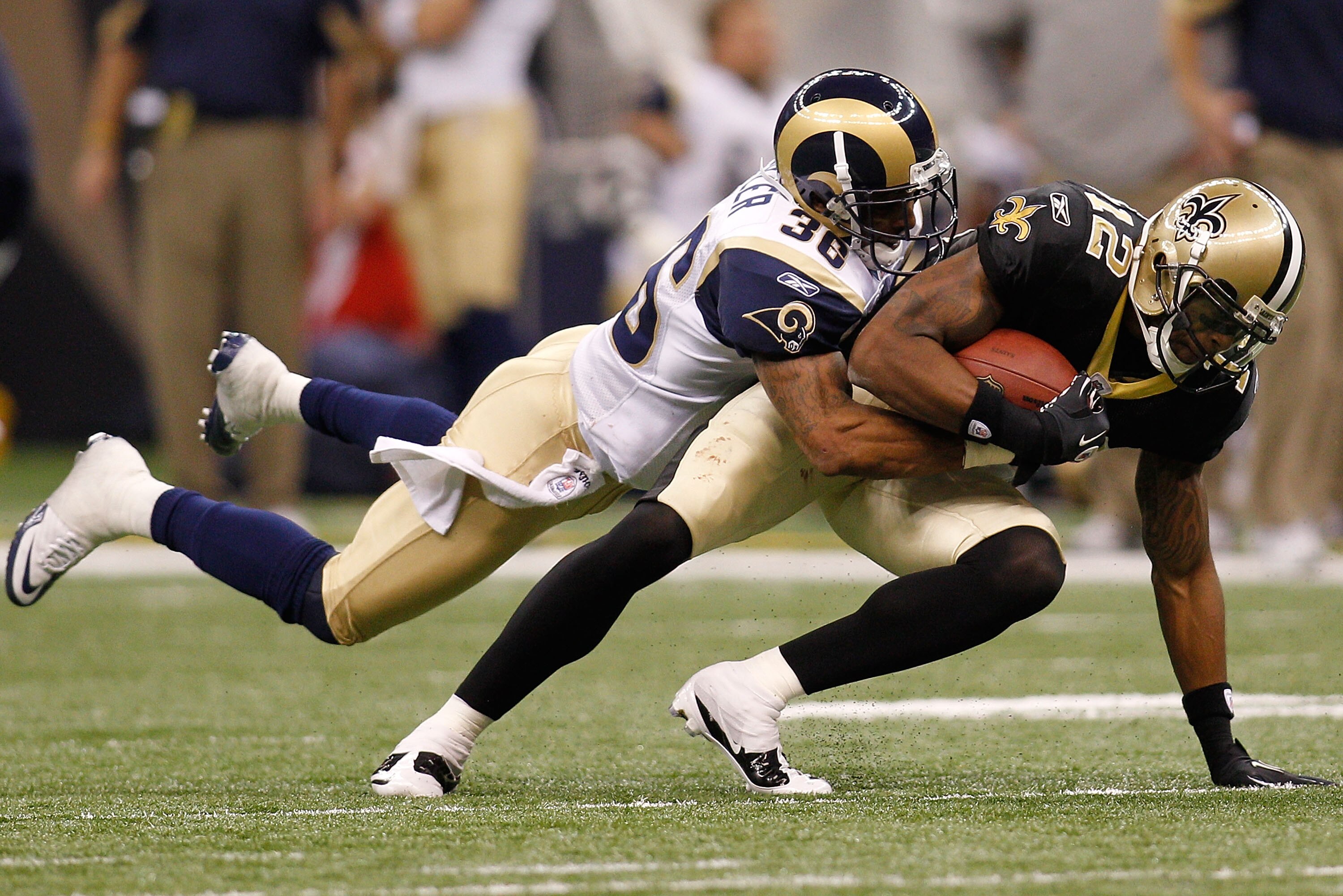NEW ORLEANS, LA - DECEMBER 12: Marques Colston #12 of the New Orleans Saints is tackled by Quincy Butler #36 of the St. Louis Rams at the Louisiana Superdome on December 12, 2010 in New Orleans, Louisiana. (Photo by Chris Graythen/Getty Images) NEW ORLEANS, LA - DECEMBER 12: Marques Colston #12 of the New Orleans Saints is tackled by Quincy Butler #36 of the St. Louis Rams at the Louisiana Superdome on December 12, 2010 in New Orleans, Louisiana. (Photo by Chris Graythen/Getty Images)