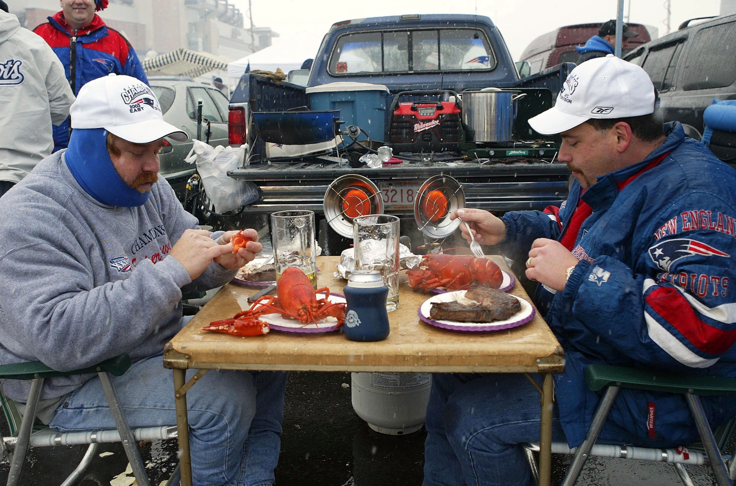 FOXBORO, MA - JANUARY 18:  Patriot fans Chris Furdon (L) and Dean Johnson enjoy a lobster and steak dinner before the Indianapolis Colts take on the New England Patriots in the AFC Championship Game on January 18, 2004 at Gillette Stadium in Foxboro, Mass