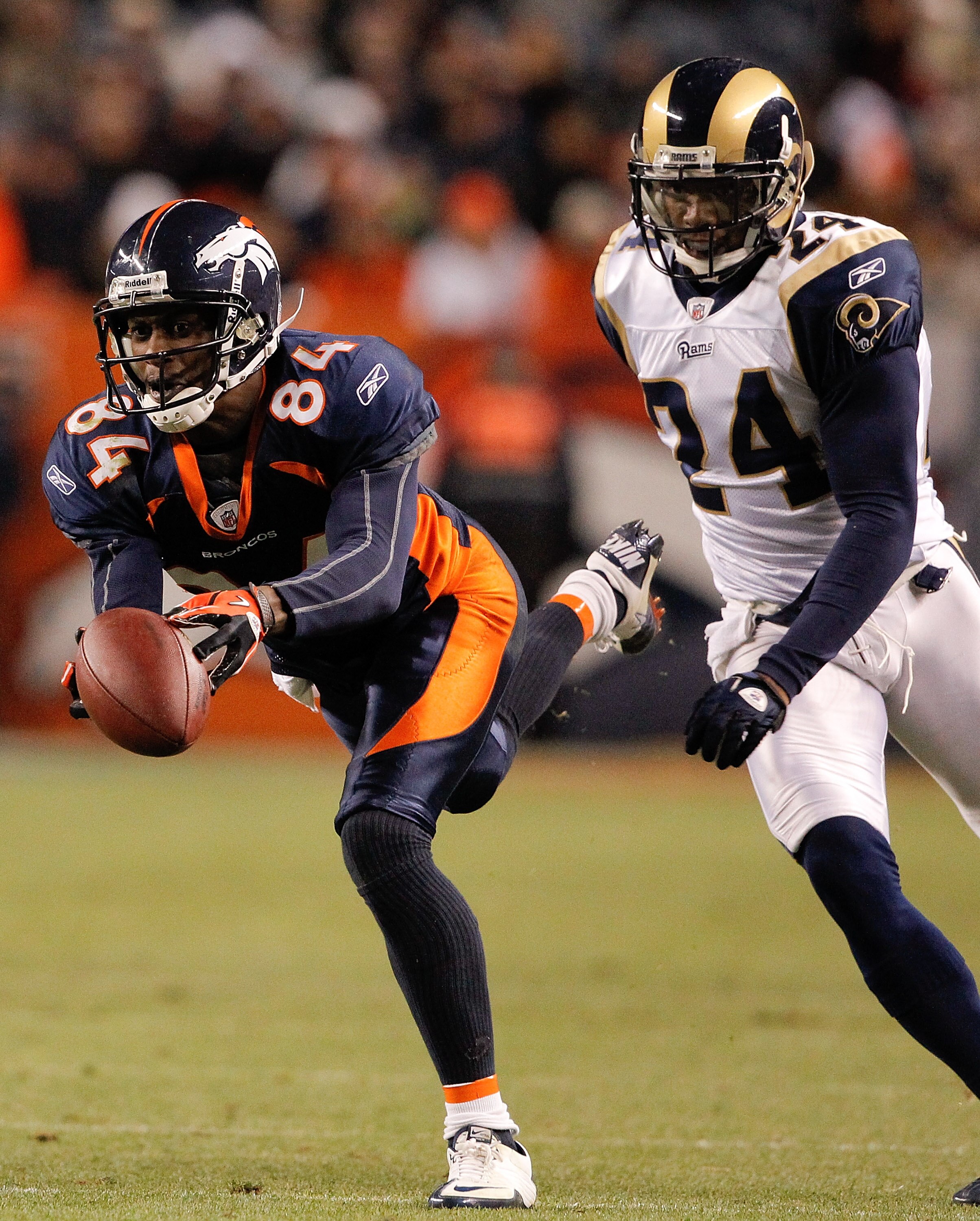 DENVER - NOVEMBER 28: A pass from Kyle Orton slips through the fingertips of wide receiver Brandon Lloyd #84 of the Denver Broncos as corner back Ronald Bartell #24 of the St. Louis Rams defends during the fourth quarter at INVESCO Field at Mile High on DENVER - NOVEMBER 28: A pass from Kyle Orton slips through the fingertips of wide receiver Brandon Lloyd #84 of the Denver Broncos as corner back Ronald Bartell #24 of the St. Louis Rams defends during the fourth quarter at INVESCO Field at Mile High on