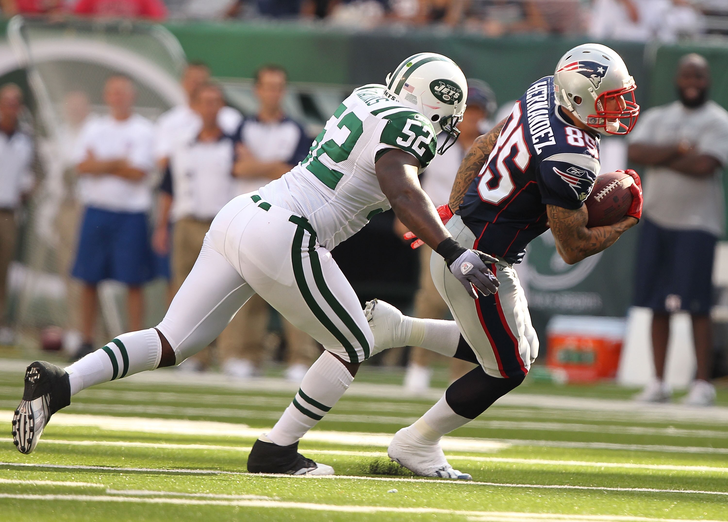 EAST RUTHERFORD, NJ - SEPTEMBER 19: David Harris #52 of the New York Jets tackles Aaron Hernandez #85 of the New England Patriots during their  game on September 19, 2010 at the New Meadowlands Stadium  in East Rutherford, New Jersey.  (Photo by Al Bello/