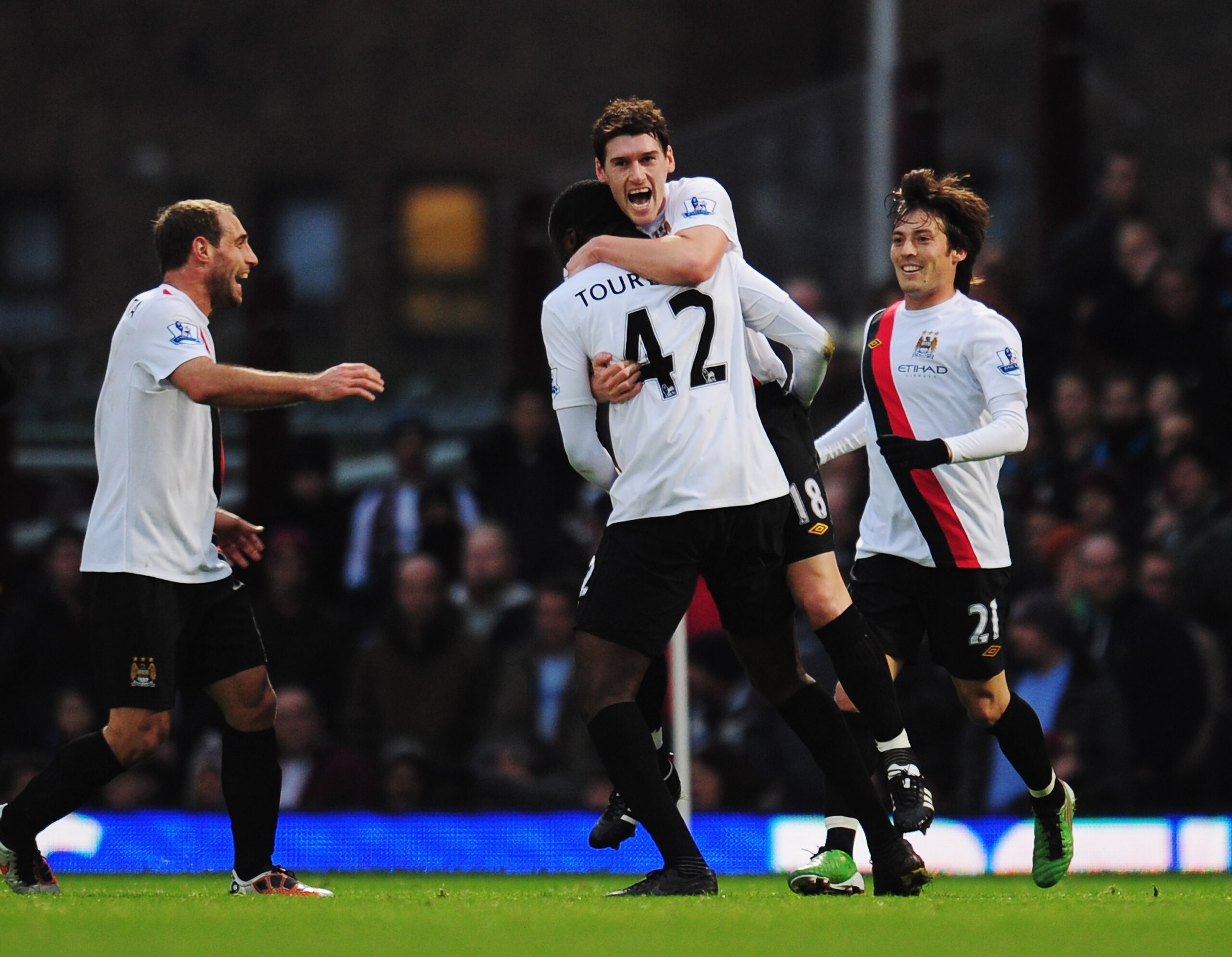 LONDON, UNITED KINGDOM - DECEMBER 11:  Kolo Toure of Manchester City is congratulated by team mate Gareth Barry after scoring during the Barclays Premier League match between West Ham United and Manchester City at Upton Park on December 11, 2010 in London
