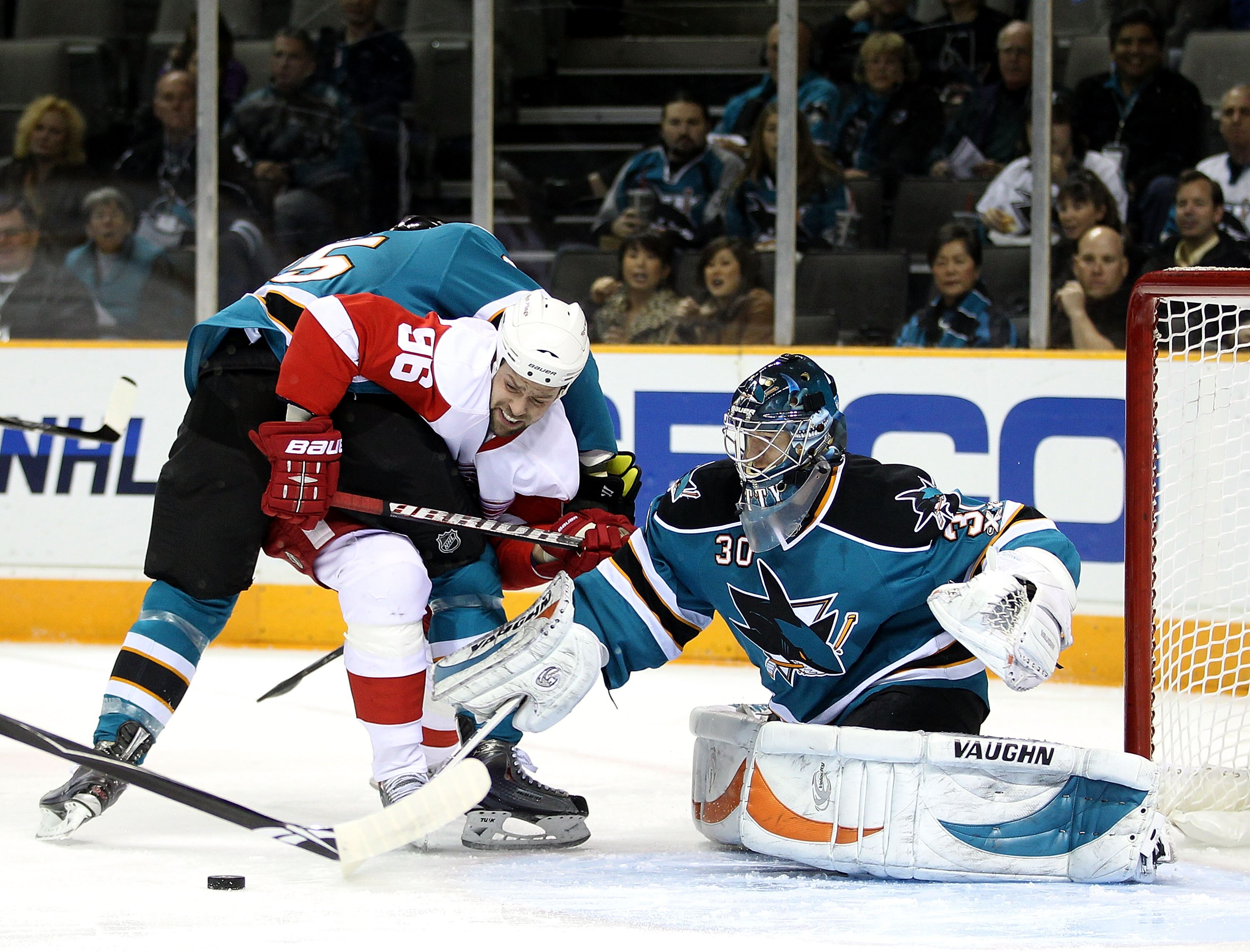 SAN JOSE, CA - NOVEMBER 30:  Tomas Holmstrom #96 of the Detroit Red Wings tries to score on Derek Joslin #65 of the San Jose Sharks and Antero Niittymaki #30 of the San Jose Sharks at HP Pavilion on November 30, 2010 in San Jose, California.  (Photo by Ez