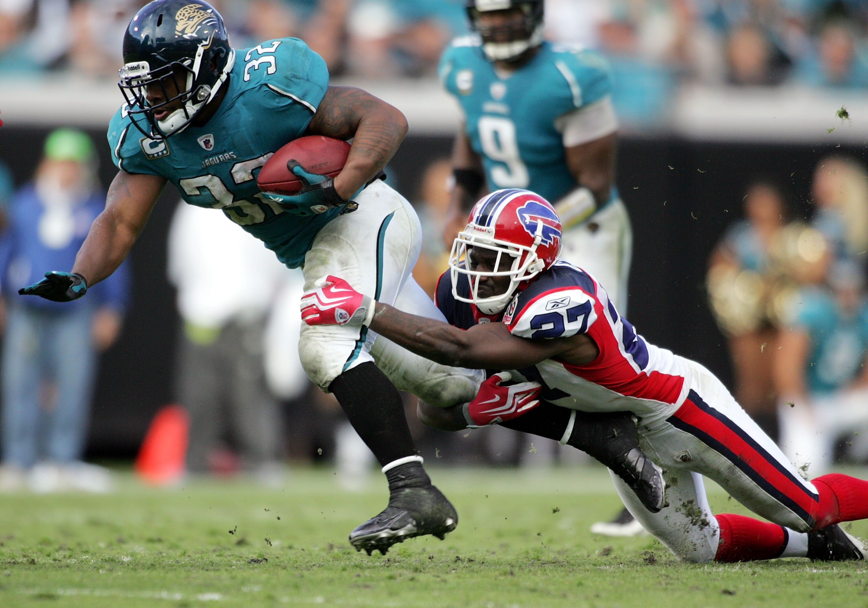 JACKSONVILLE, FL - NOVEMBER 22:  Running back  Maurice Jones Drew #32 of the Jacksonville Jaguars  is brought down by cornerback Rahean Mathis #27 of  the Buffalo Bills at Jacksonville Municipal Stadium on November 22, 2009 in Jacksonville, Florida. Jacks