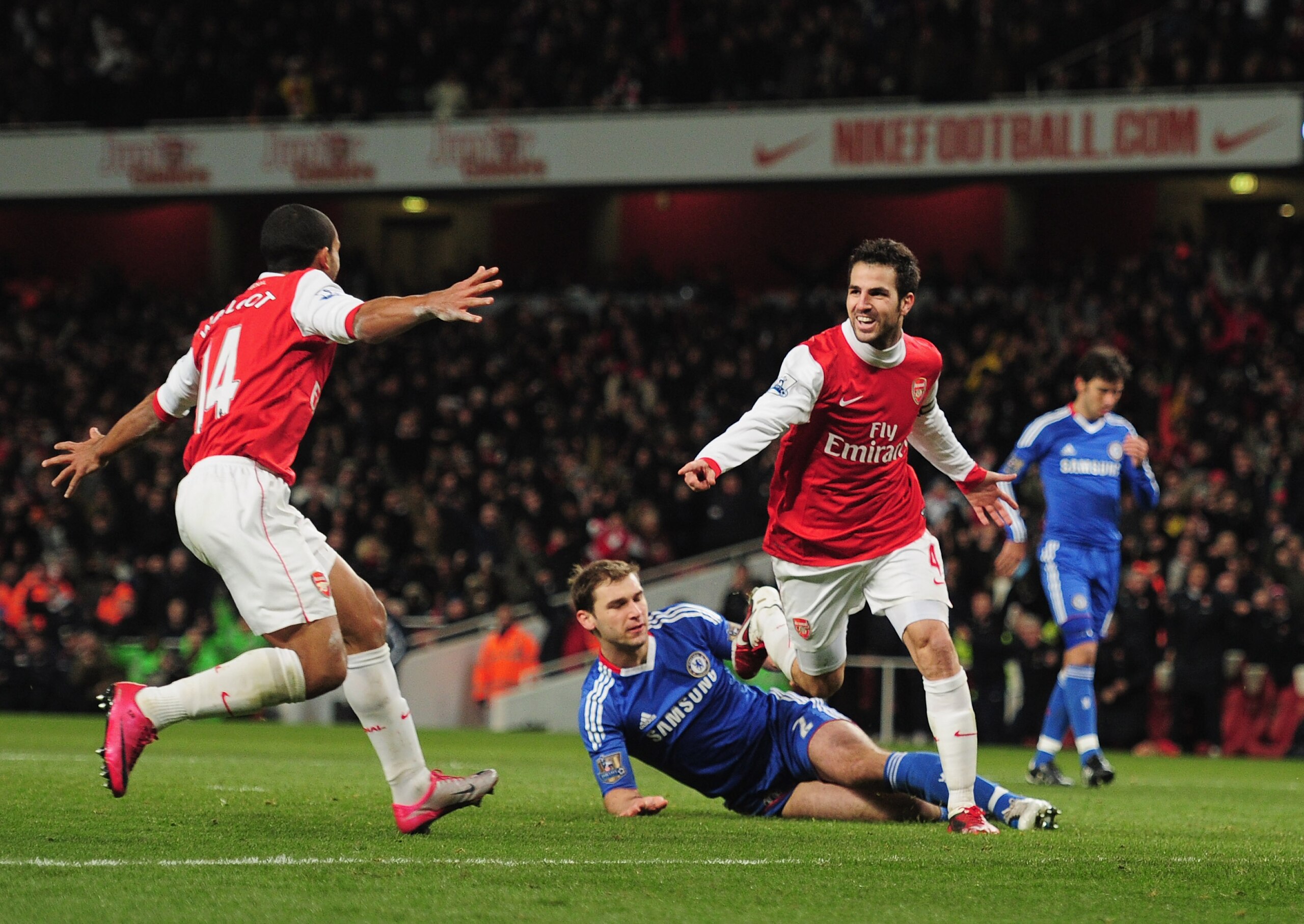 LONDON, ENGLAND - DECEMBER 27:  Cesc Fabregas of Arsenal celebrates Arsenal's second goal with Theo Walcott (L) during the Barclays Premier League match between Arsenal and Chelsea at the Emirates Stadium on December 27, 2010 in London, England.  (Photo b