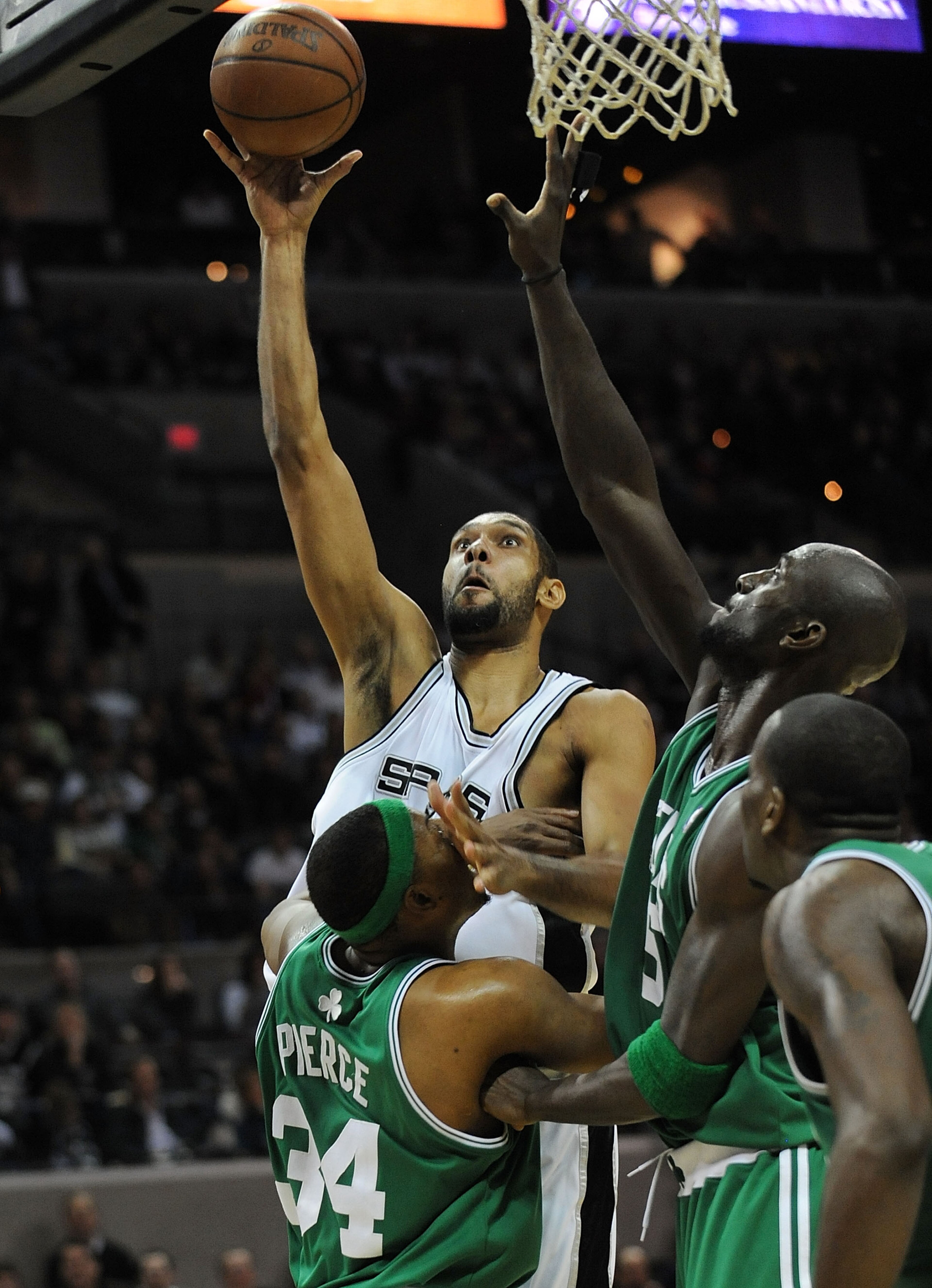 SAN ANTONIO - DECEMBER 03: Forward Tim Duncan #21 of the San Antonio Spurs takes a shot against Paul Pierce #34 and Kevin Garnett #5 of the Boston Celtics on December 3, 2009 at AT&T Center in San Antonio, Texas. NOTE TO USER: User expressly acknowledge SAN ANTONIO - DECEMBER 03: Forward Tim Duncan #21 of the San Antonio Spurs takes a shot against Paul Pierce #34 and Kevin Garnett #5 of the Boston Celtics on December 3, 2009 at AT&T Center in San Antonio, Texas. NOTE TO USER: User expressly acknowledge