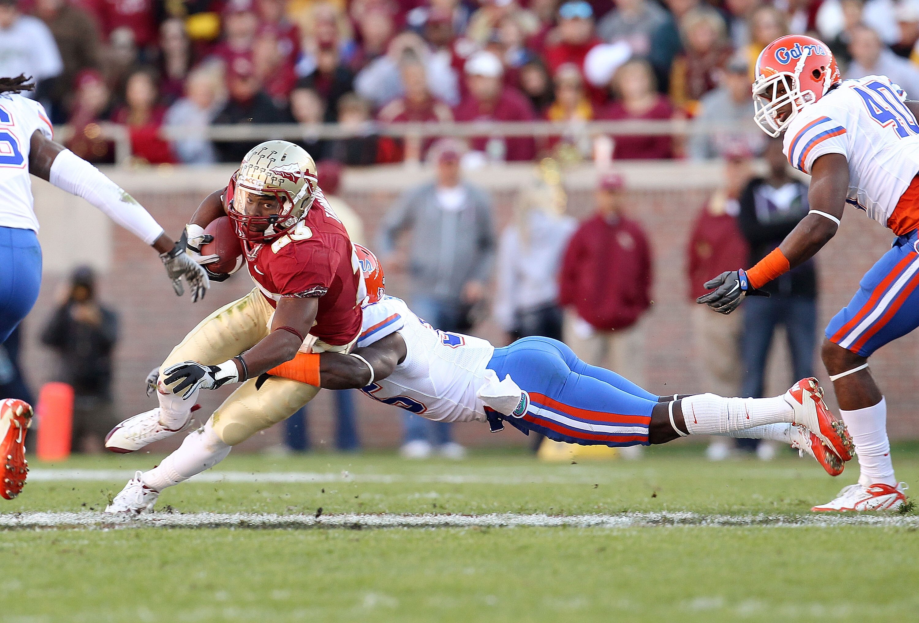 TALLAHASSEE, FL - NOVEMBER 27:  Chris Thompson #23 of the Florida State Seminoles runs after a catch before being tackled by Moses Jenkins #36 of the Florida Gatorsduring a game at Doak Campbell Stadium on November 27, 2010 in Tallahassee, Florida.  (Phot