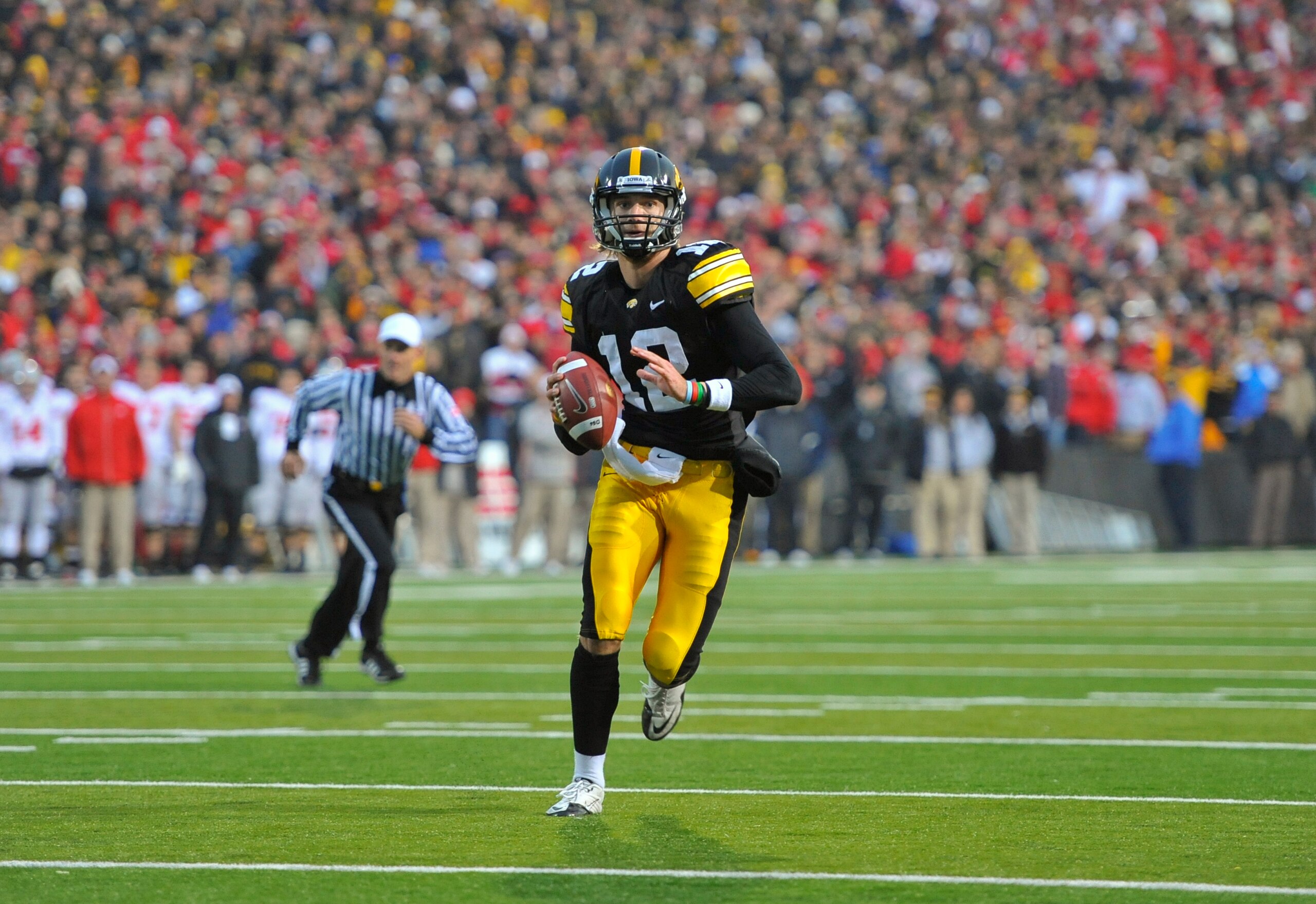 IOWA CITY, IA - NOVEMBER 20:  Quarterback Ricky Stanzi #12 of the University of Iowa Hawkeyes scrambles for yards under pressure from the Ohio State Buckeyes at Kinnick Stadium on November 20, 2010 in Iowa City, Iowa. Ohio State won 20-17 over Iowa. (Phot