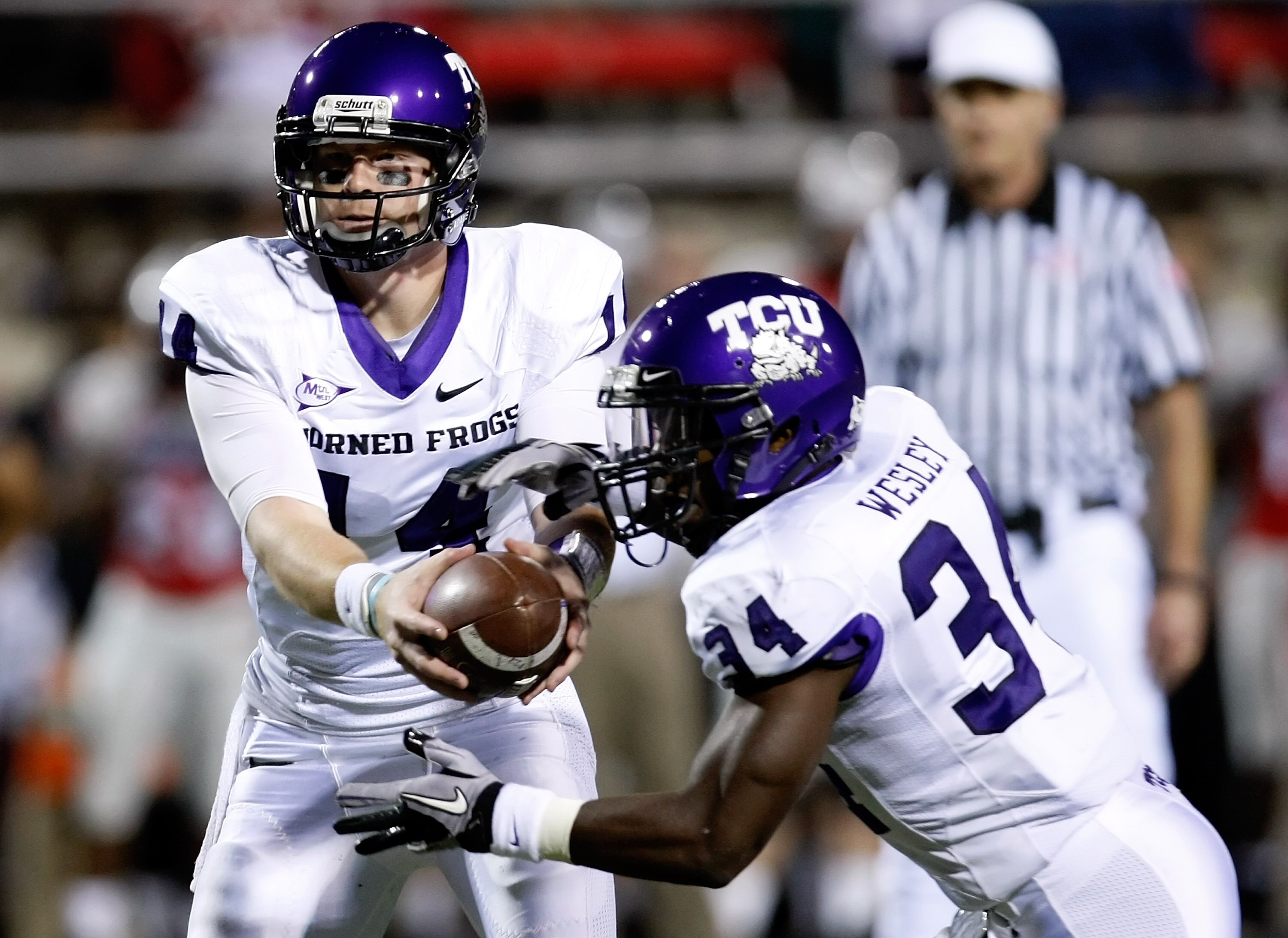 LAS VEGAS - OCTOBER 30:  Quarterback Andy Dalton #14 of the Texas Christian University Horned Frogs hands the ball off to Ed Wesley #34 during their game against the UNLV Rebels at Sam Boyd Stadium October 30, 2010 in Las Vegas, Nevada. TCU won 48-6.  (Ph