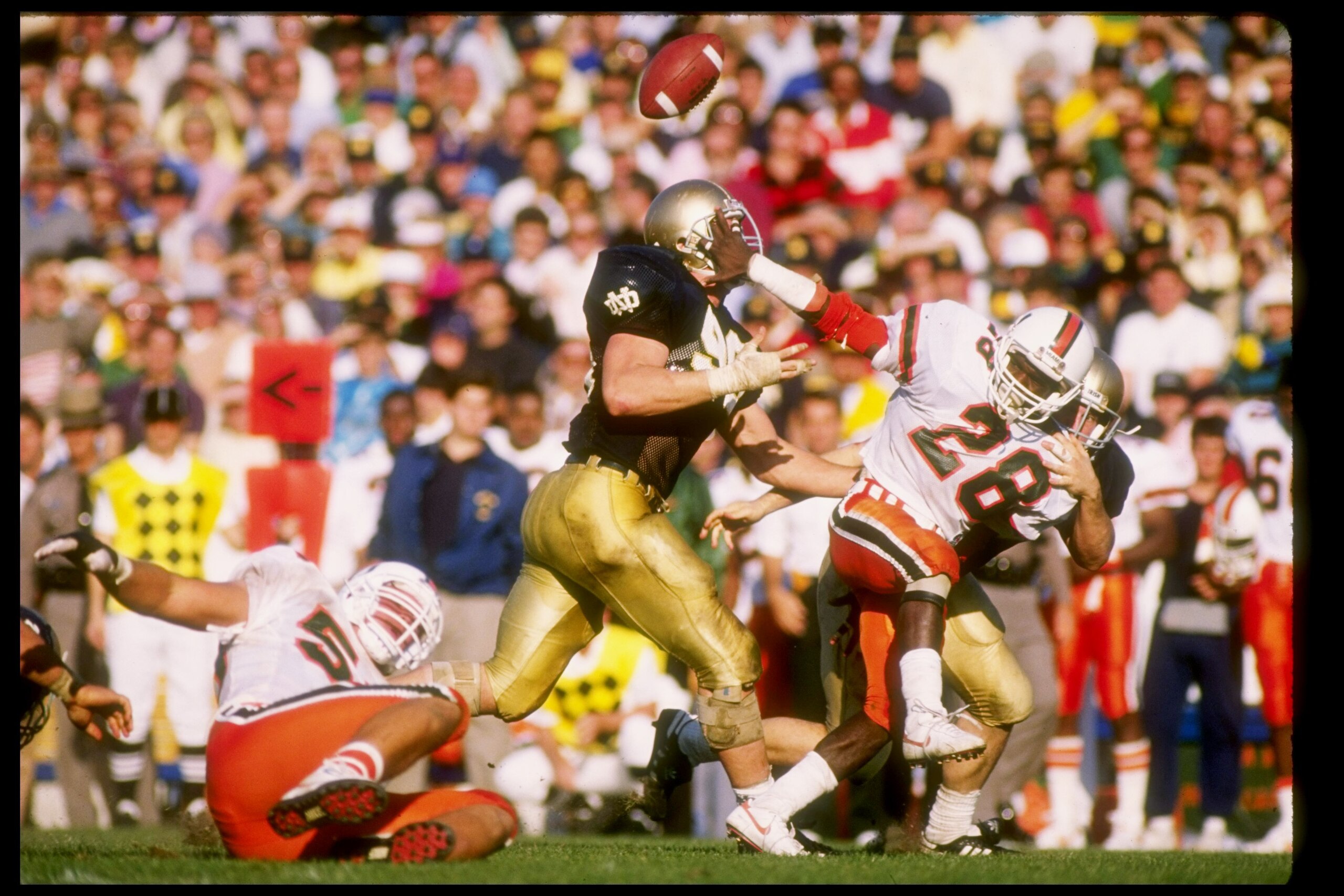 15 Oct 1988:  Running back Leonard Conley of the Miami Hurricanes tries to break a tackle during a game against the Notre Dame Fighting Irish at Notre Dame Stadium in South Bend, Indiana.  Notre Dame won the game 31-30. Mandatory Credit: Jonathan Daniel