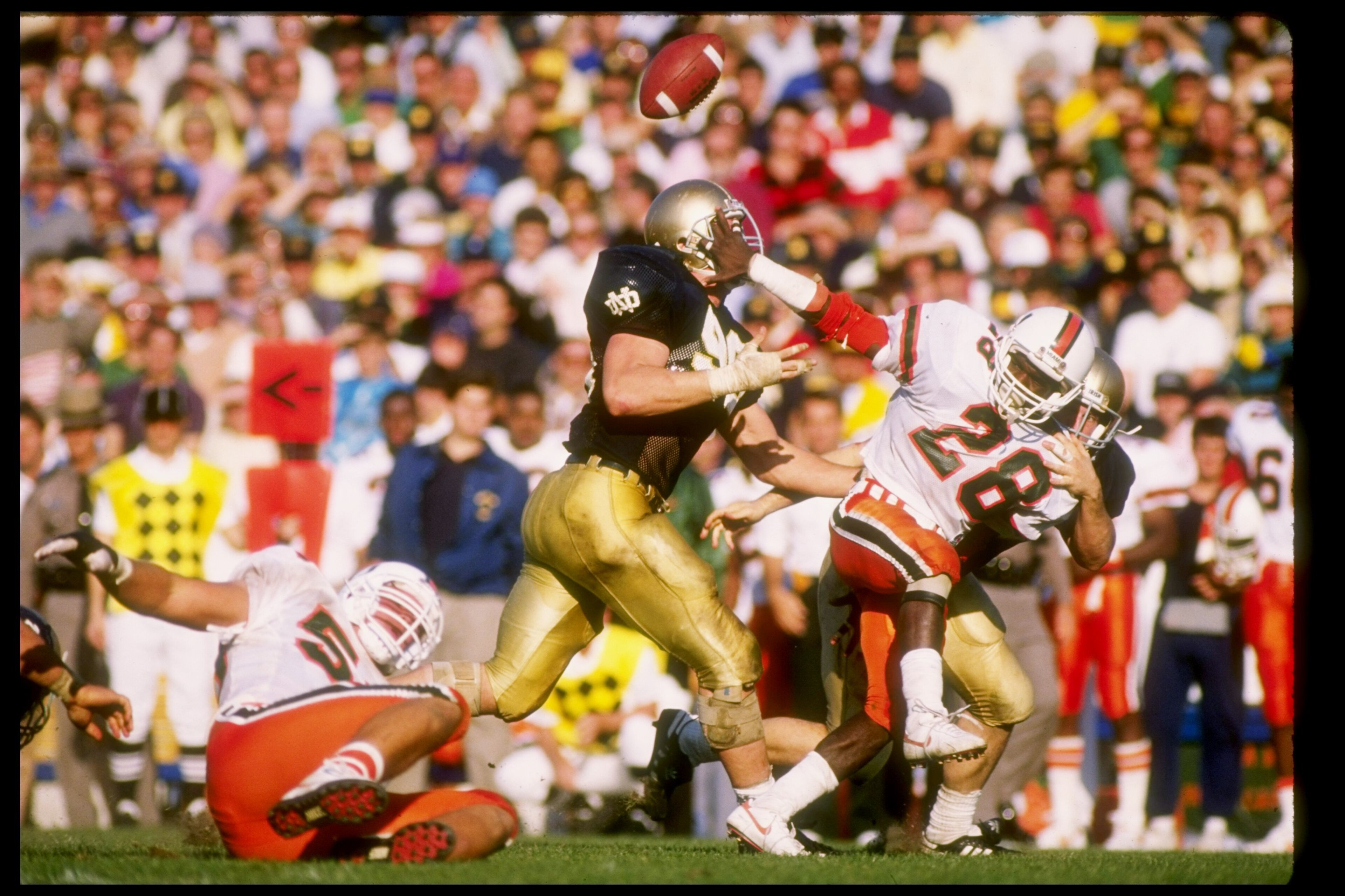 15 Oct 1988:  Running back Leonard Conley of the Miami Hurricanes tries to break a tackle during a game against the Notre Dame Fighting Irish at Notre Dame Stadium in South Bend, Indiana.  Notre Dame won the game 31-30. Mandatory Credit: Jonathan Daniel