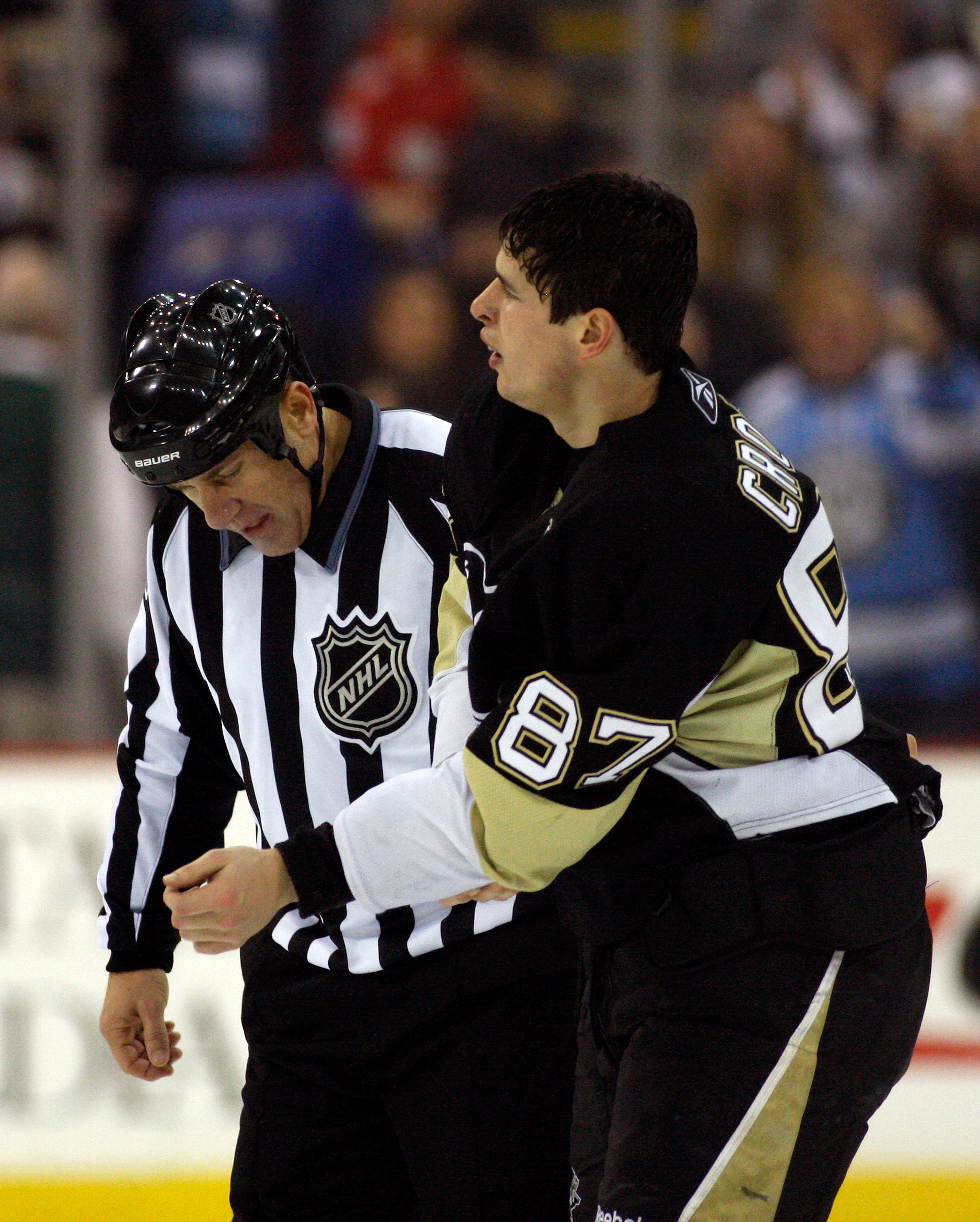PITTSBURGH, PA - OCTOBER 31:  Sidney Crosby #87 of the Pittsburgh Penguins is escorted off ice by a linesman after fighting with Marek Zidlicky #3 of the Minnesota Wild in the second period at Mellon Arena on October 31, 2009 in Pittsburgh, Pennsylvania.