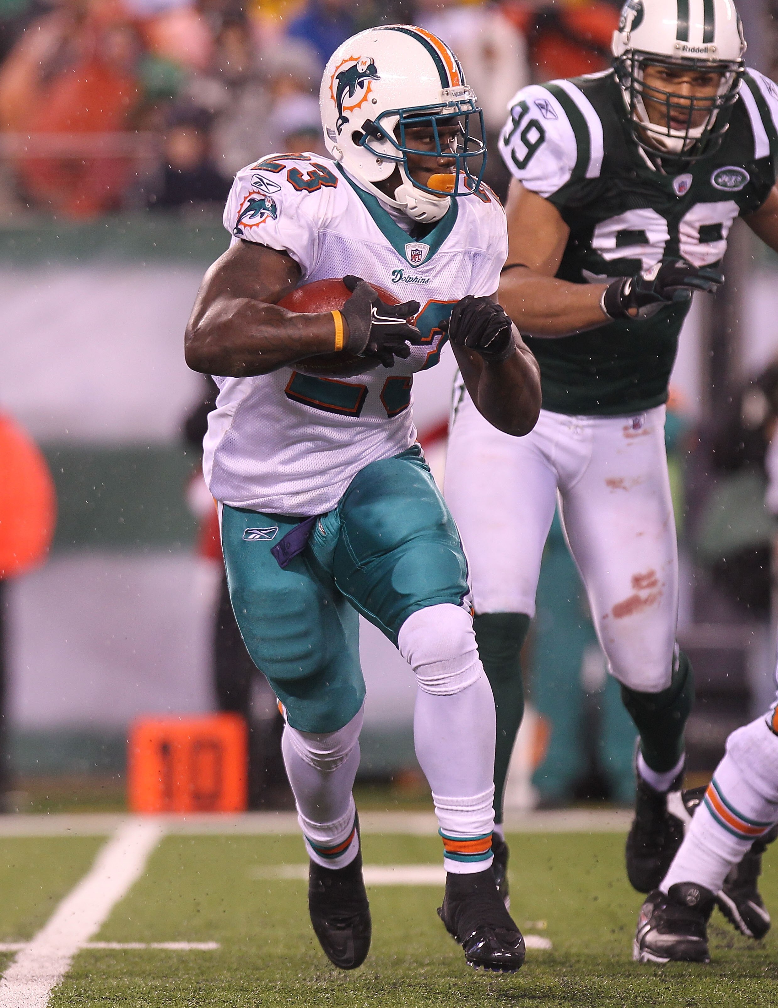 EAST RUTHERFORD, NJ - DECEMBER 12:  Ronnie Brown #23 of the Miami Dolphins rushes against the New York Jets at New Meadowlands Stadium on December 12, 2010 in East Rutherford, New Jersey.  (Photo by Nick Laham/Getty Images)