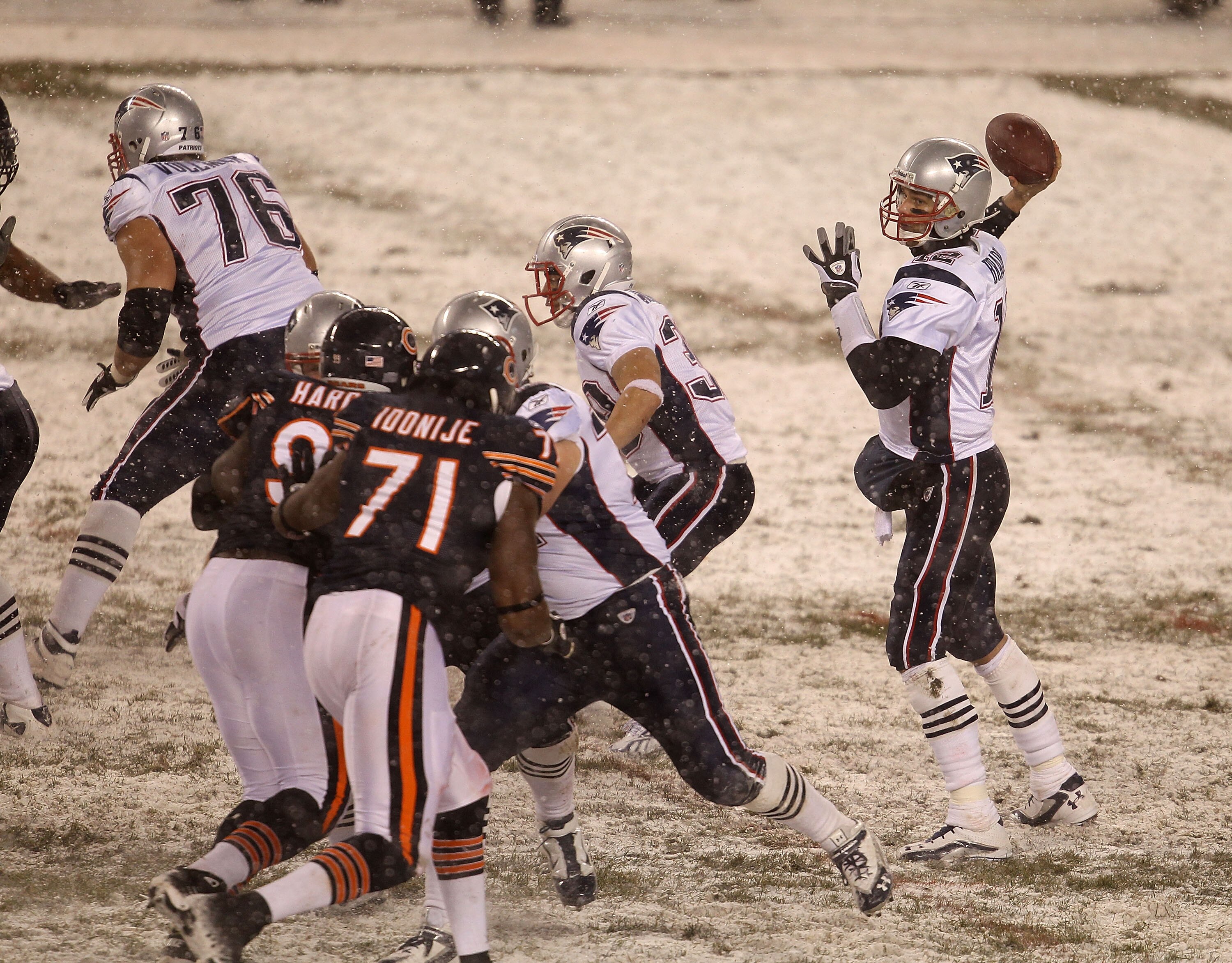 CHICAGO, IL - DECEMBER 12: Tom Brady #12 of the New England Patriots throws a pass as Tommie Harris #91 and Israel Idonije #71 of the Chicago Bears rush at Soldier Field on December 12, 2010 in Chicago, Illinois. The Patriots defeated the Bears 36-7. (Pho
