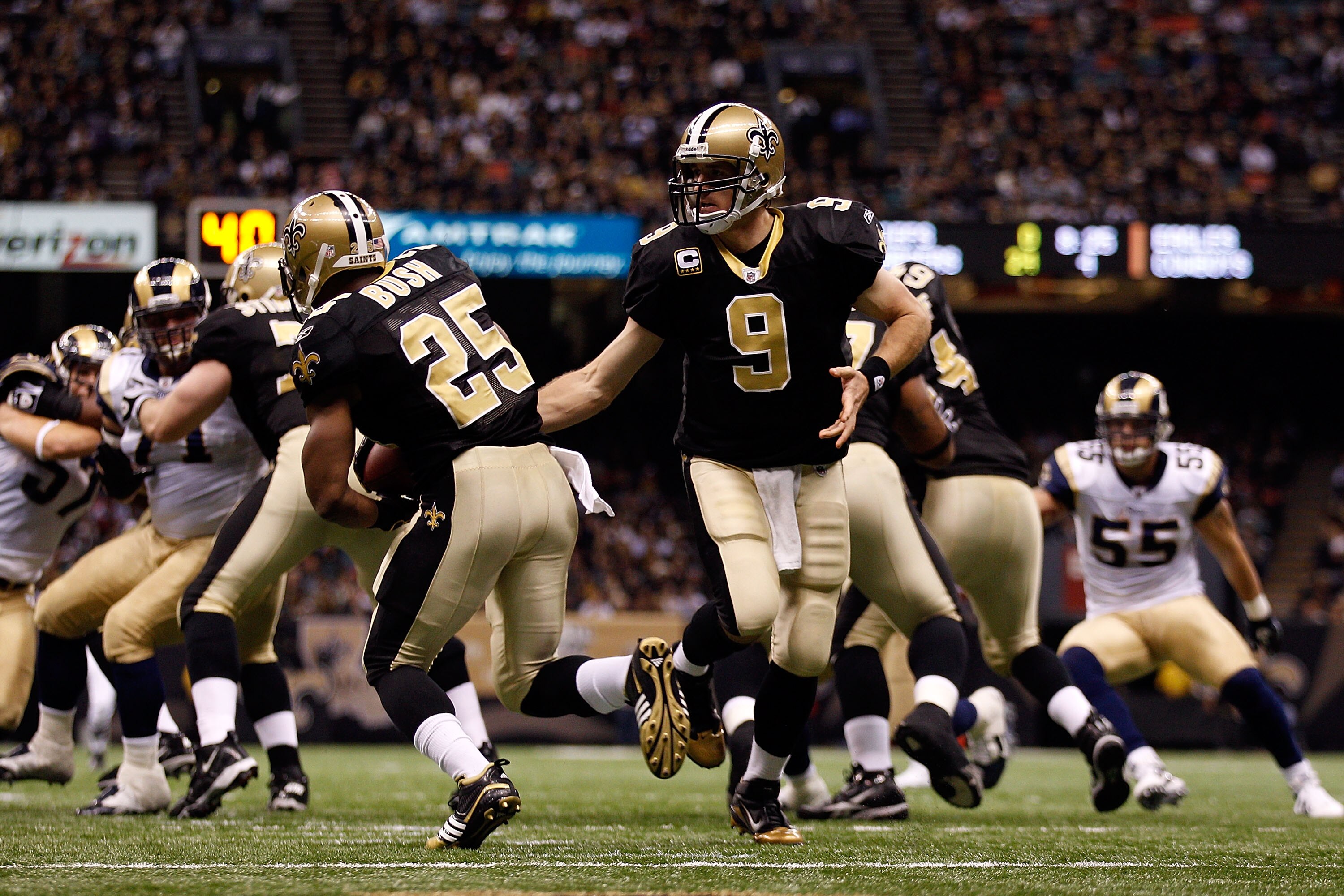 NEW ORLEANS, LA - DECEMBER 12:  Drew Brees #9 hands the ball off to Reggie Bush #25 of the New Orleans Saints during the game against the St. Louis Rams at the Louisiana Superdome on December 12, 2010 in New Orleans, Louisiana. The Saints defeated the Ram