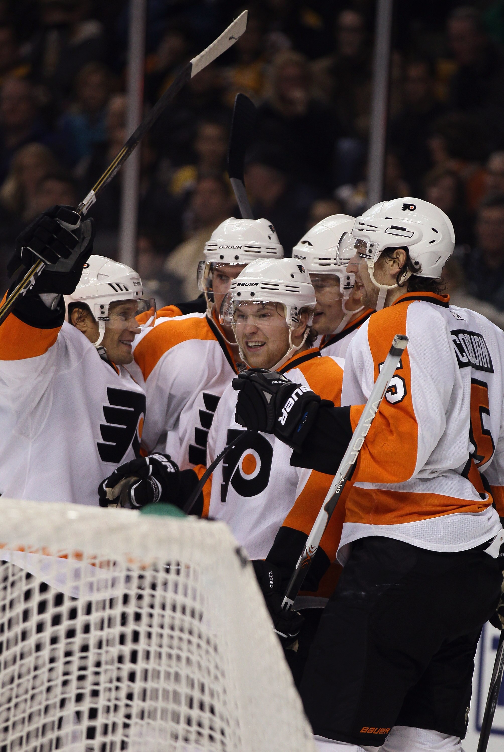 BOSTON, MA - DECEMBER 11:  James van Riemsdyk #21 of the Philadelphia Flyers is congratulated by teammates Claude Giroux #28 and Braydon Coburn #5 in the second period against the Boston Bruins on December 11, 2010 at the TD Garden in Boston, Massachusett