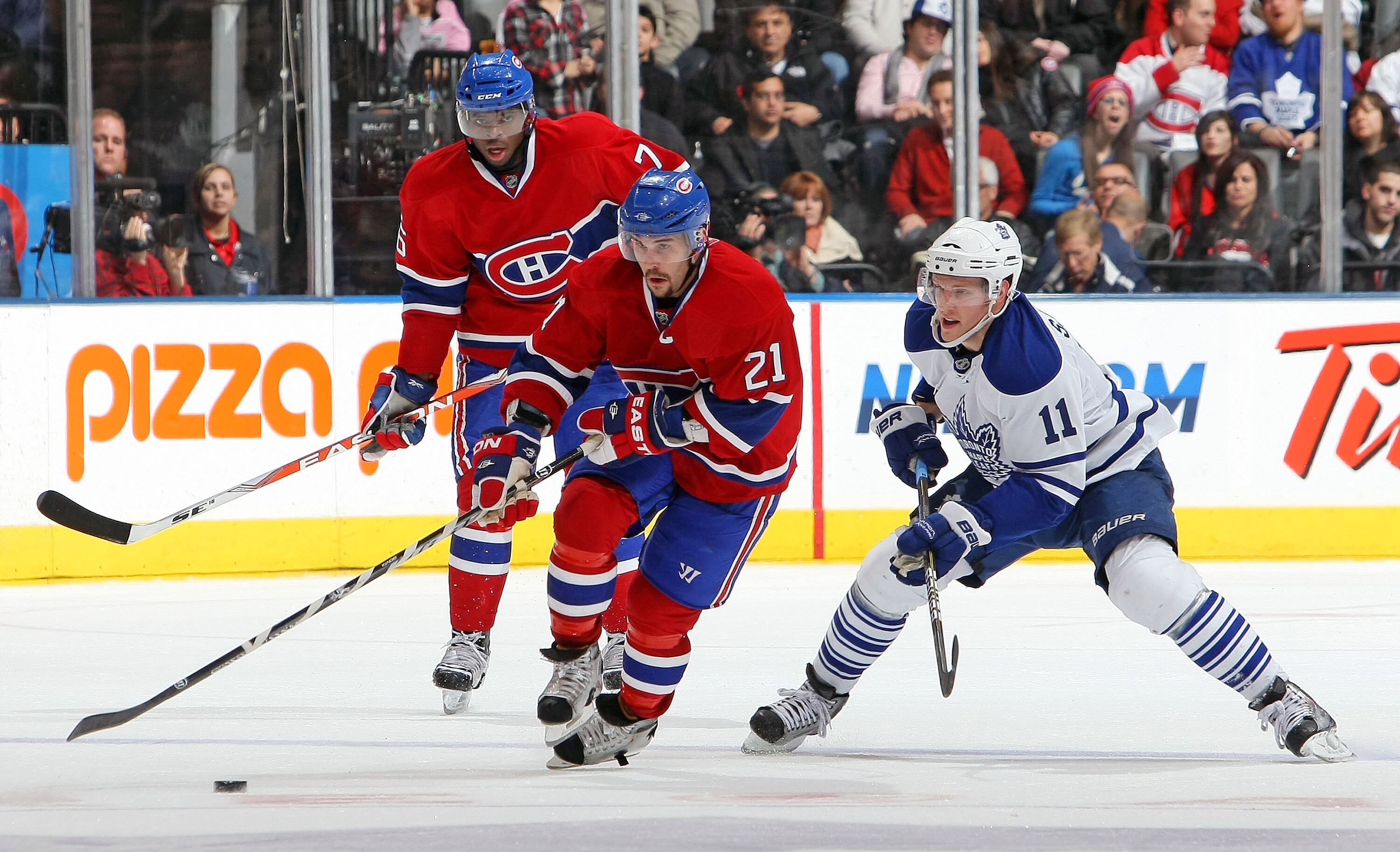 TORONTO - DECEMBER 11:  Fredrik Sjostrom #11 of the Toronto Maple Leafs backchecks against Brian Gionta #21 of the Montreal Canadiens during their NHL game at Air Canada Centre on December 11, 2010 in Toronto, Ontario, Canada.(Photo By Dave Sandford/Getty