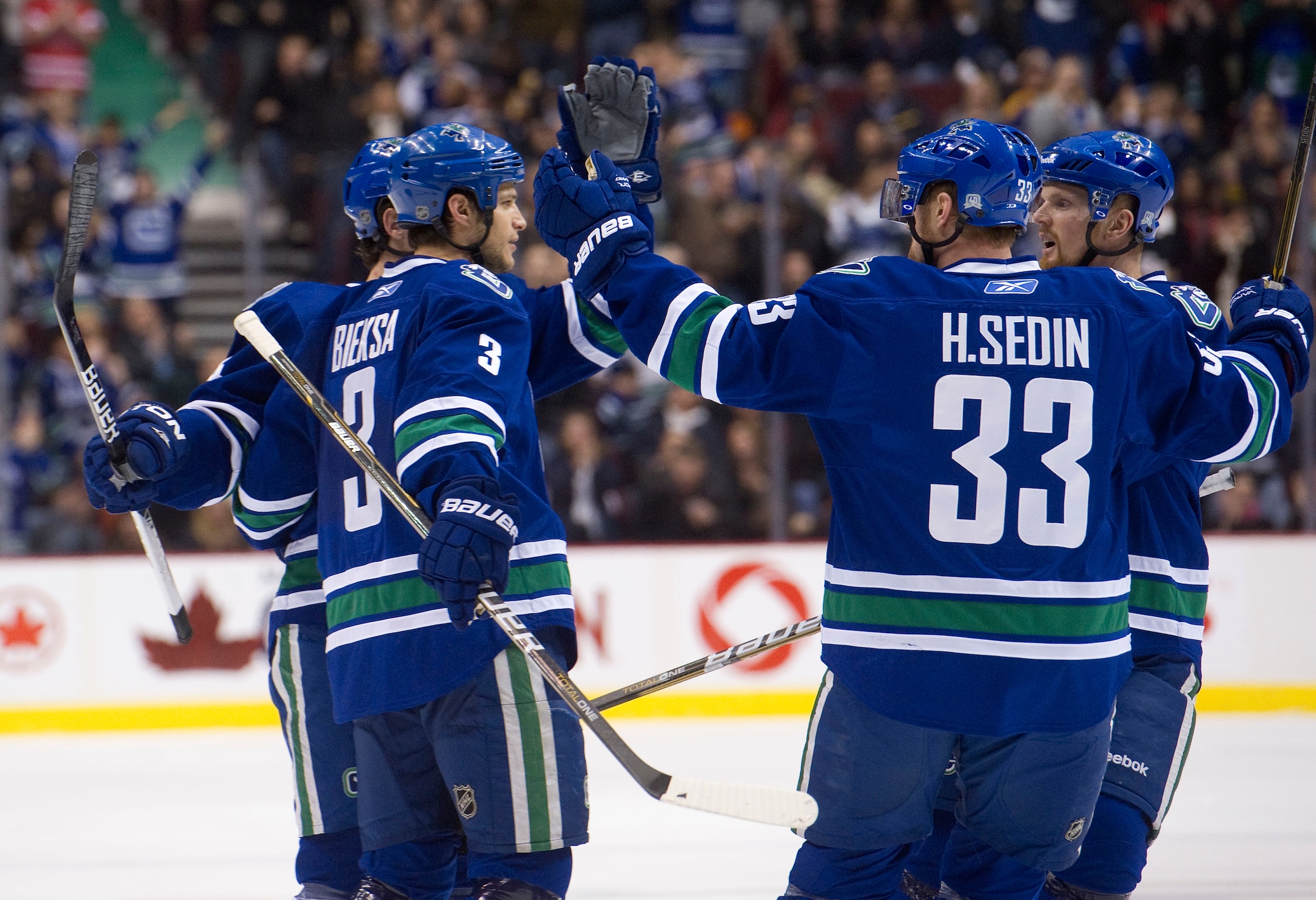 VANCOUVER, CANADA - DECEMBER 5: Kevin Bieksa #3 of the Vancouver Canucks is congratulated by Keith Ballard #4, Henrik Sedin #33 and Daniel Sedin #22 after scoring against the St Louis Blues during the second period in NHL action on December 05, 2010 at Ro VANCOUVER, CANADA - DECEMBER 5: Kevin Bieksa #3 of the Vancouver Canucks is congratulated by Keith Ballard #4, Henrik Sedin #33 and Daniel Sedin #22 after scoring against the St Louis Blues during the second period in NHL action on December 05, 2010 at Ro