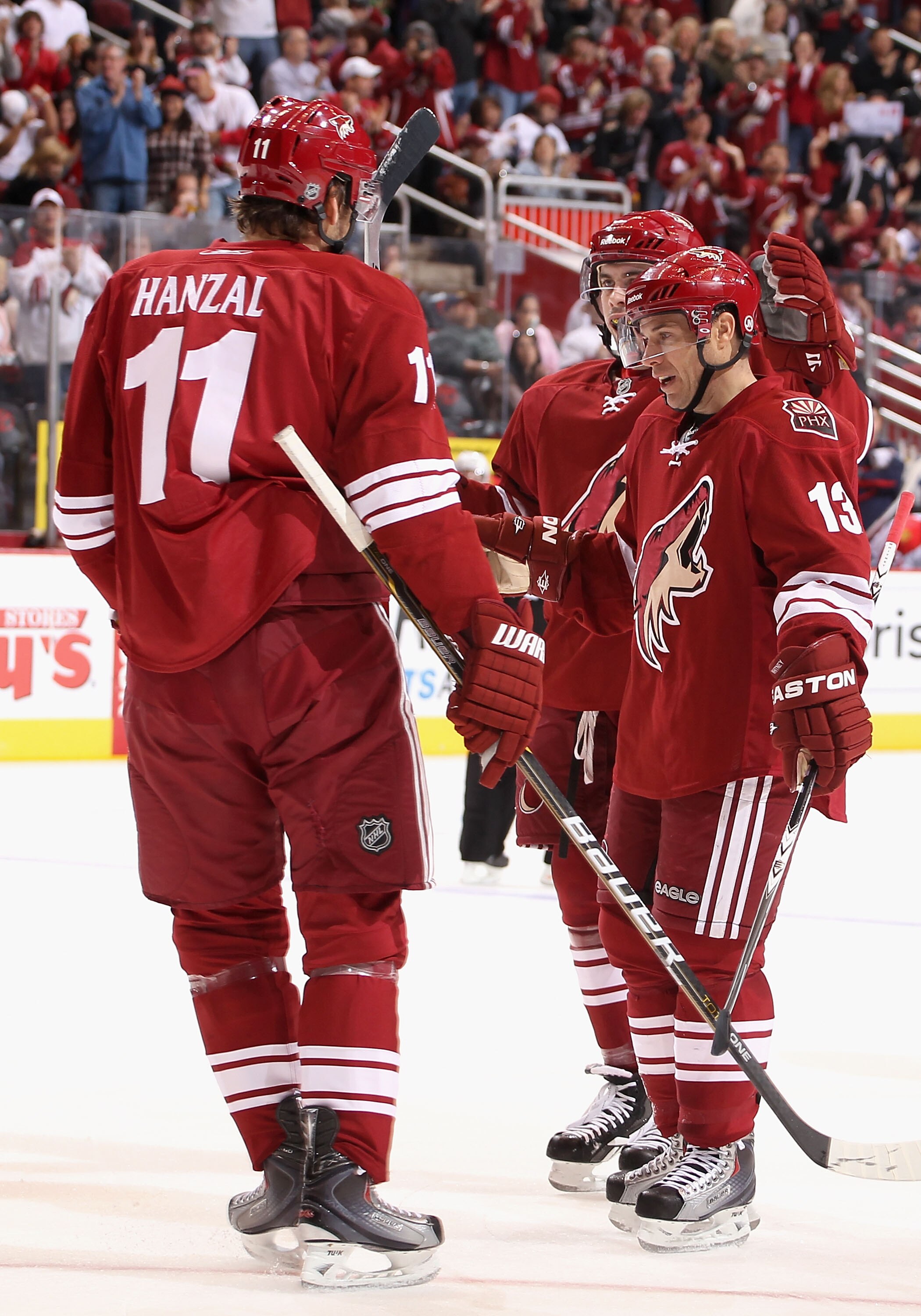 GLENDALE, AZ - DECEMBER 04:  Martin Hanzal #11, Keith Yandle #3 and Ray Whitney #13 of the Phoenix Coyotes celebrate after scoring during the NHL game against the Florida Panthers at Jobing.com Arena on December 4, 2010 in Glendale, Arizona.  The Panthers