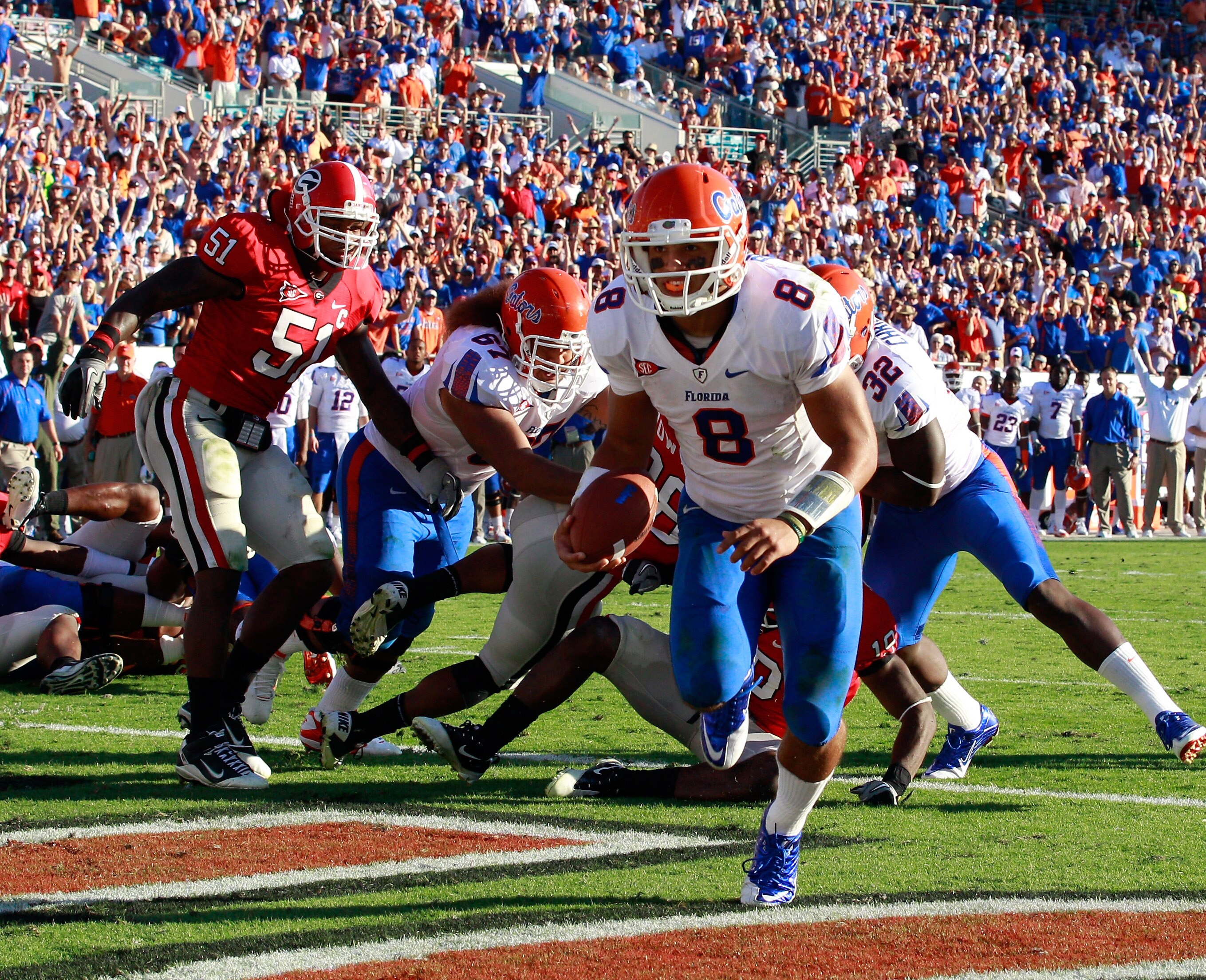 JACKSONVILLE, FL - OCTOBER 30:  Quarterback Trey Burton #8 of the Florida Gators runs for a touchdown during the game against the Georgia Bulldogs at EverBank Field on October 30, 2010 in Jacksonville, Florida.  (Photo by Sam Greenwood/Getty Images)