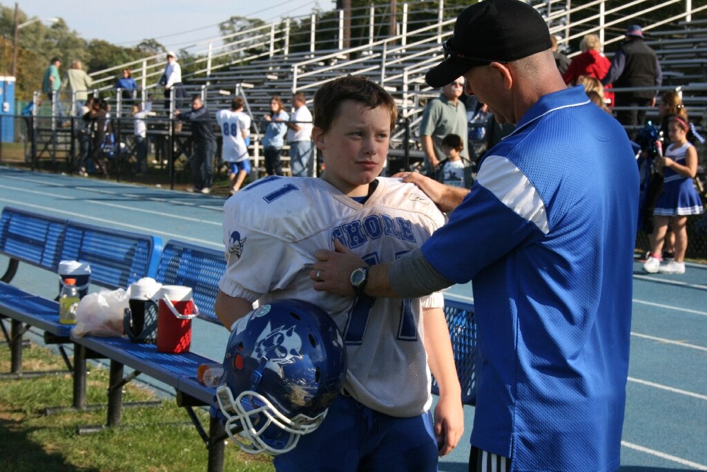 Last game of the season.  Coach telling him he worked his ass off.