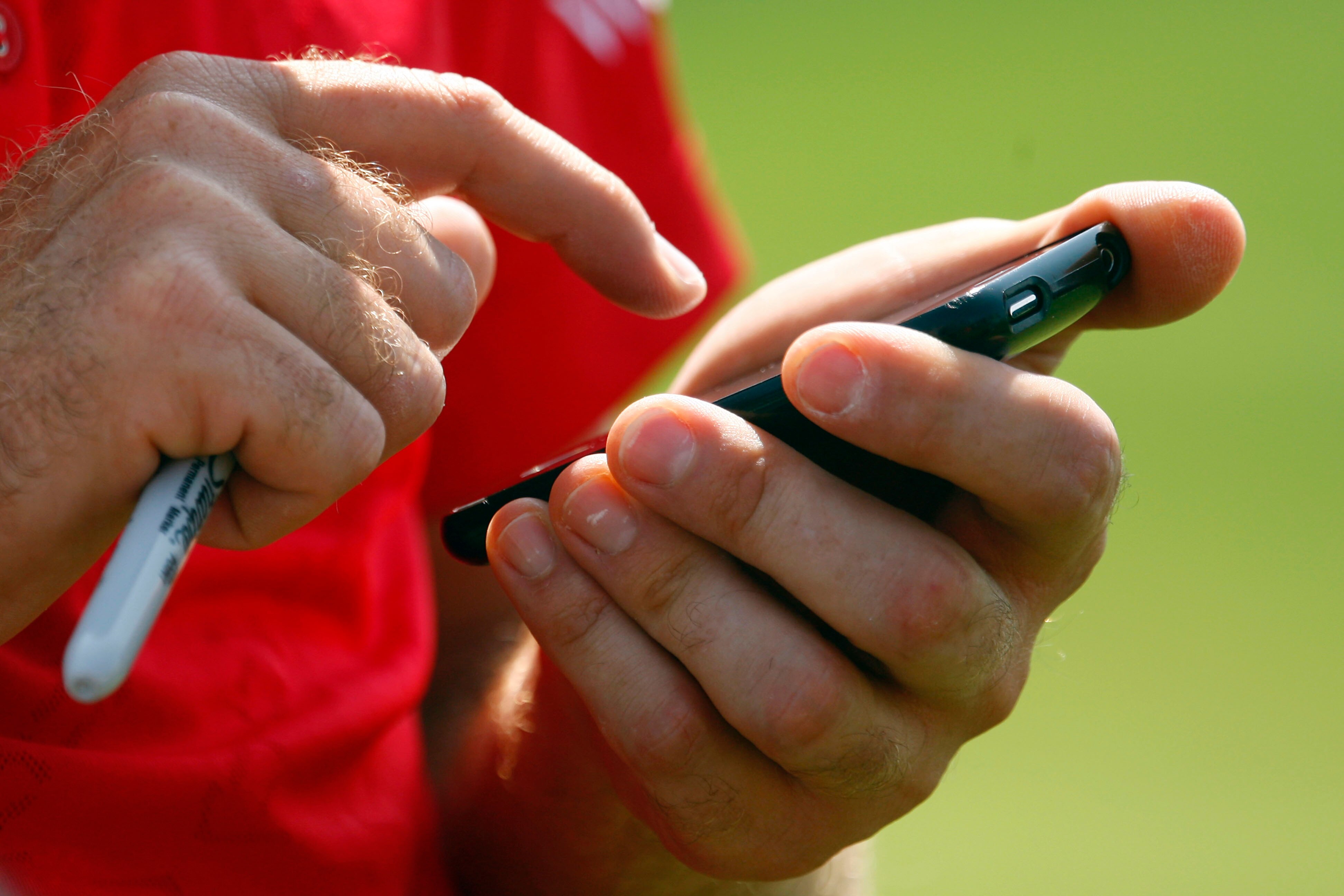 CHASKA, MN - AUGUST 11:  Ian Poulter of England uses his phone during the second preview day of the 91st PGA Championship at Hazeltine National Golf Club on August 11, 2009 in Chaska, Minnesota.  (Photo by Scott Halleran/Getty Images)