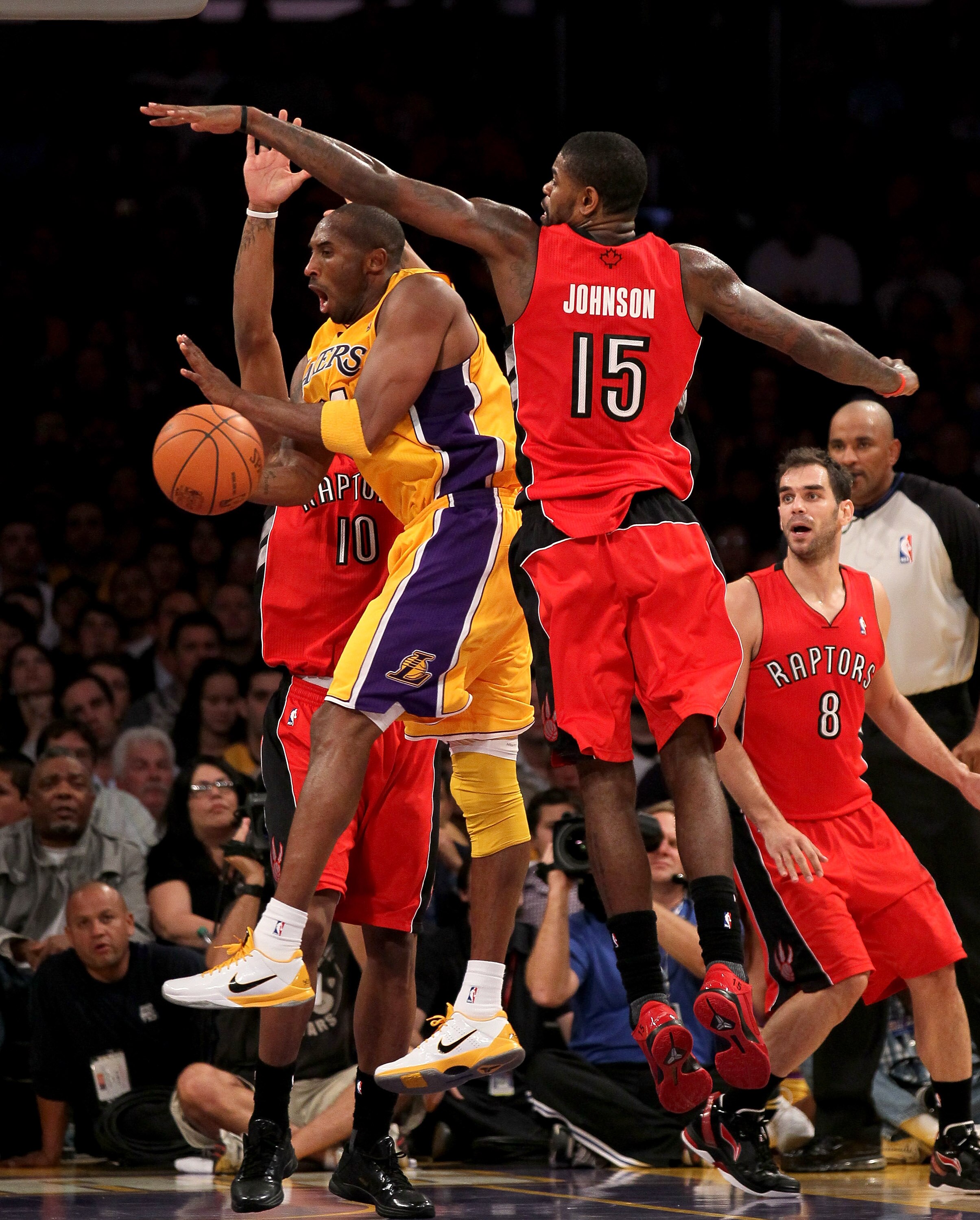 LOS ANGELES - NOVEMBER 5: Kobe Bryant #24 of the Los Angeles Lakers controls the ball against Amir Johnson #15 of the Toronto Raptors at Staples Center on November 5, 2010 in Los Angeles, California.  The Lakers won 108-102.   NOTE TO USER: User expressly
