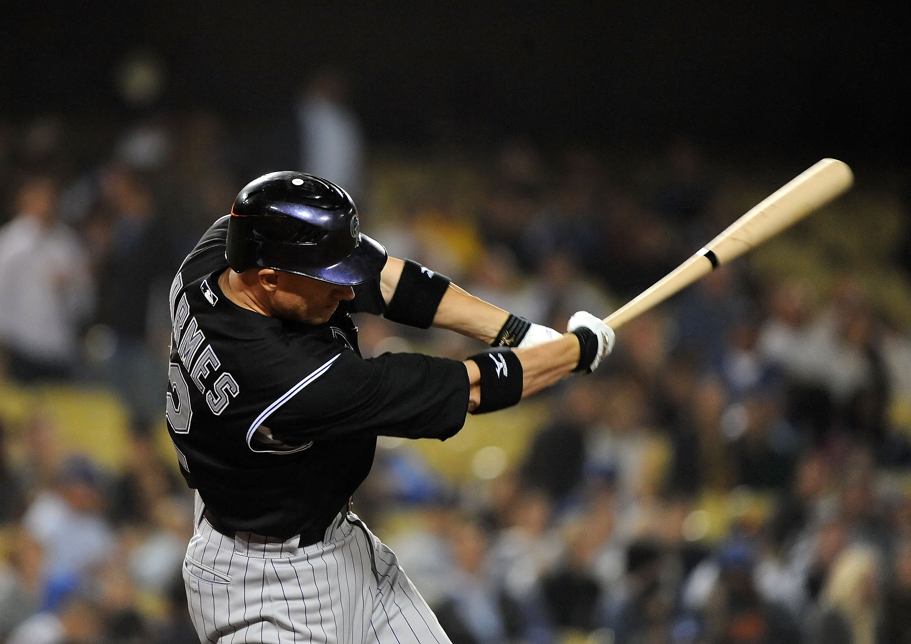 LOS ANGELES, CA - SEPTEMBER 17:  Clint Barmes #12 of the Colorado Rockies hits a single in the eighth inning against the Los Angeles Dodgers at Dodger Stadium on September 17, 2010 in Los Angeles, California.  (Photo by Lisa Blumenfeld/Getty Images)