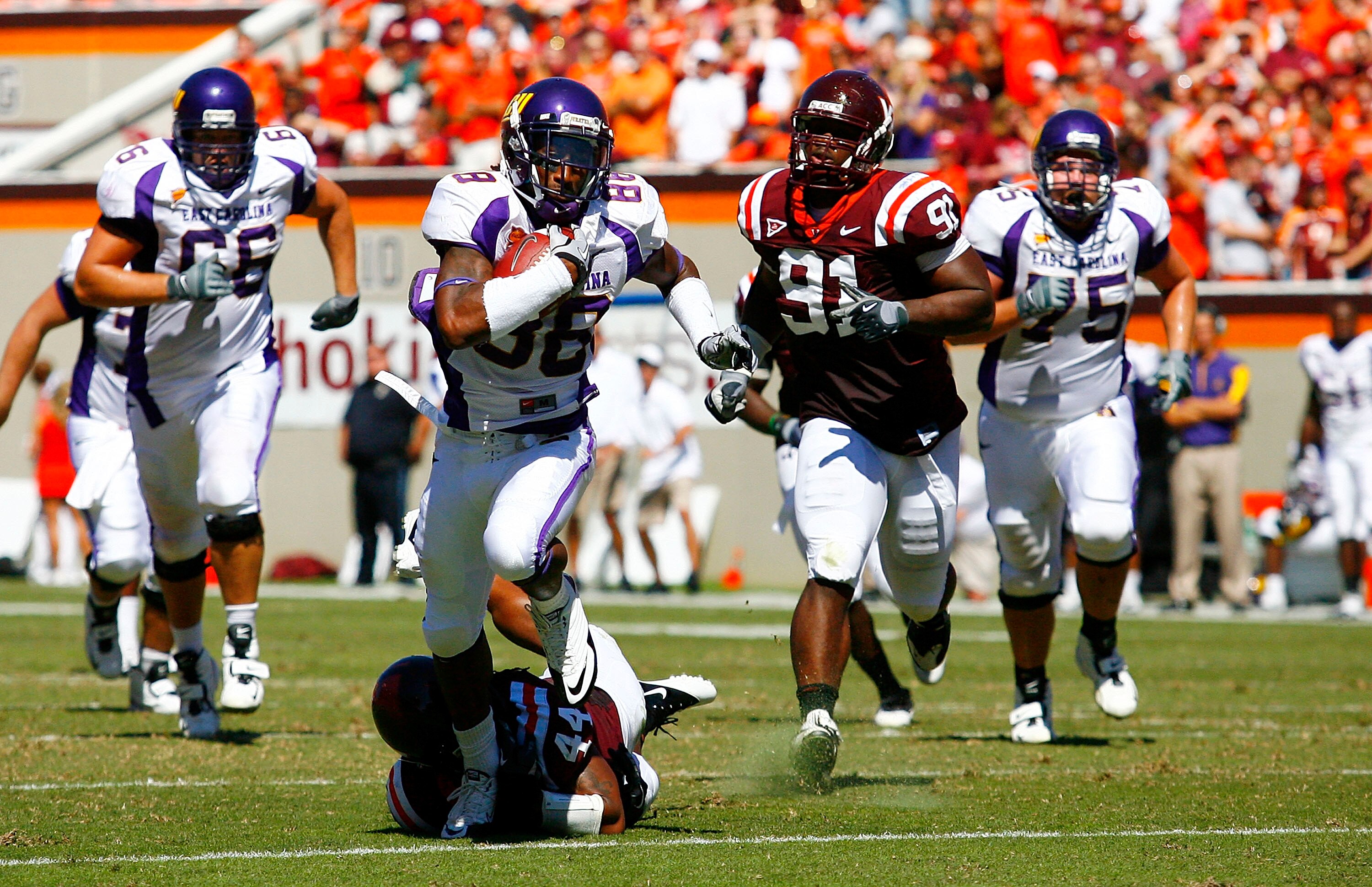BLACKSBURG, VA - SEPTEMBER 18:  Wide receiver Lance Lewis #88 of the East Carolina Pirates runs with the ball as linebacker Lyndell Gibson #44 of the Virginia Tech Hokies tries to make the tackle at Lane Stadium on September 18, 2010 in Blacksburg, Virgin