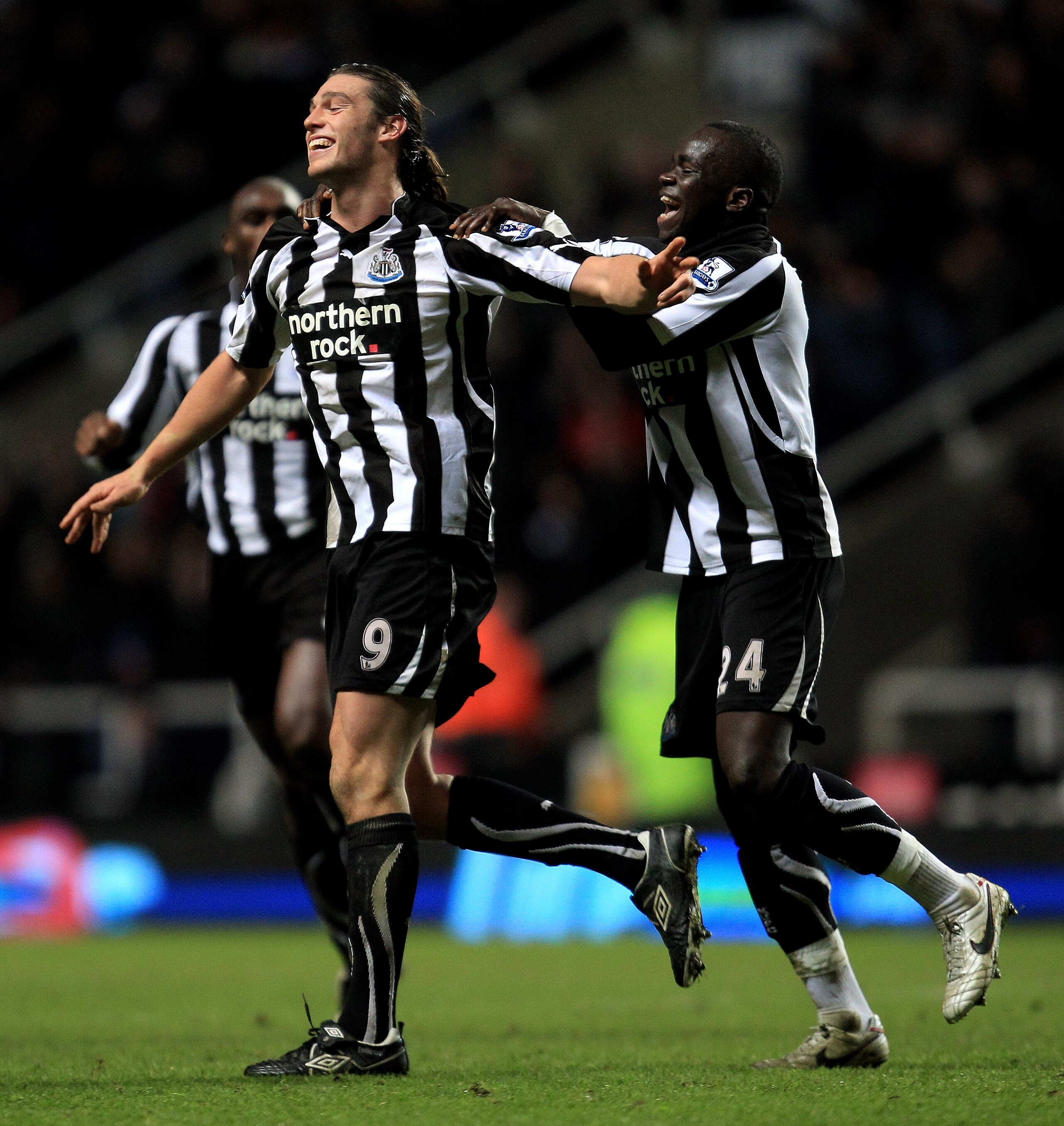 NEWCASTLE UPON TYNE, ENGLAND - DECEMBER 11:  Andy Carroll of Newcastle United celebrates scoring his team's third goal with team mate Cheik Tiote (R) during the Barclays Premier League match between Newcastle United and Liverpool at St James' Park on Dece