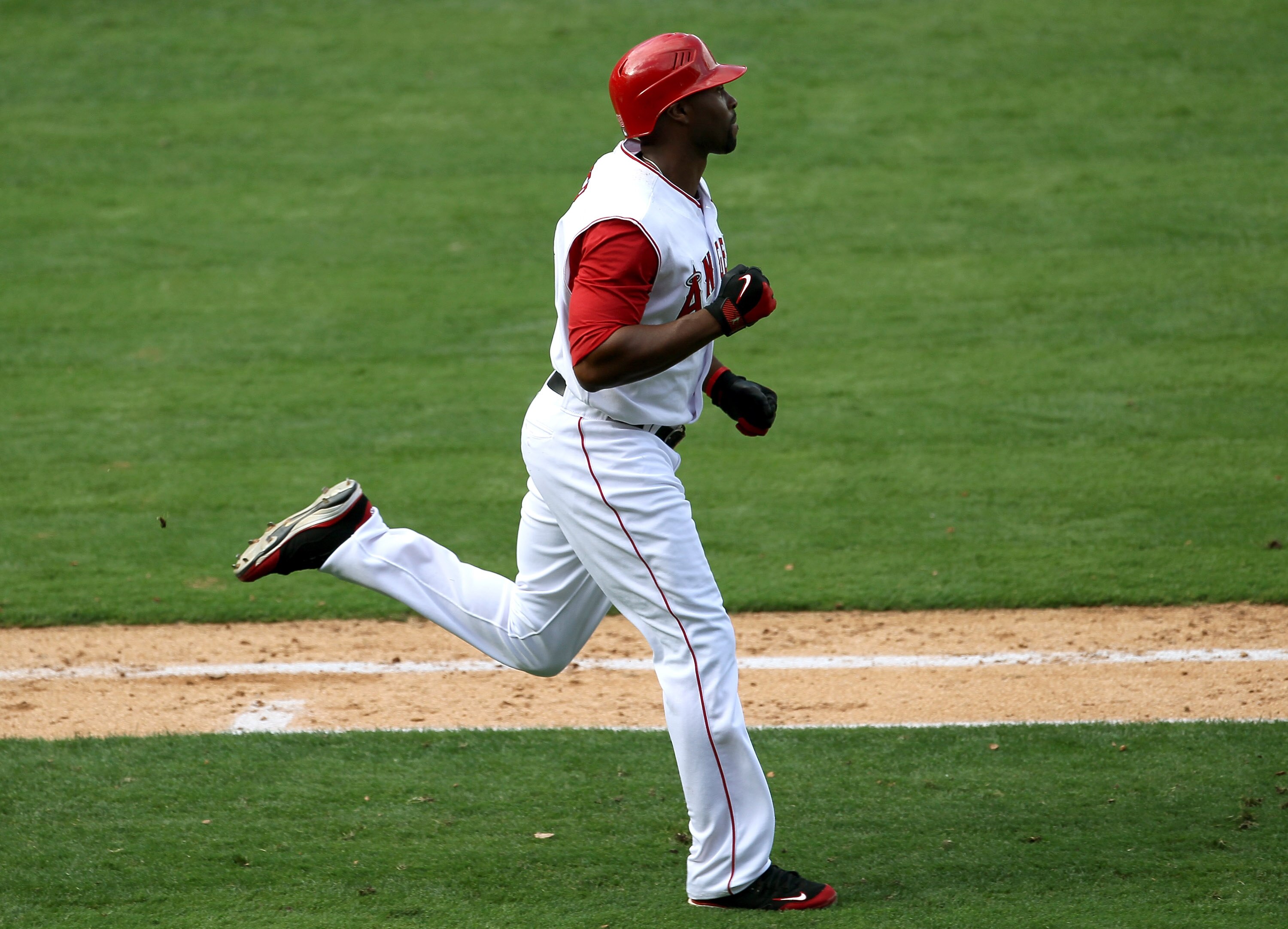 ANAHEIM, CA - SEPTEMBER 29:  Torii Hunter #48 of the Los Angeles Angels of Anaheim pumps his fist as he runs to first base with a walk off single in the 11th inning to win the game with the Oakland Athletics on September 29, 2010 at Angel Stadium in Anahe
