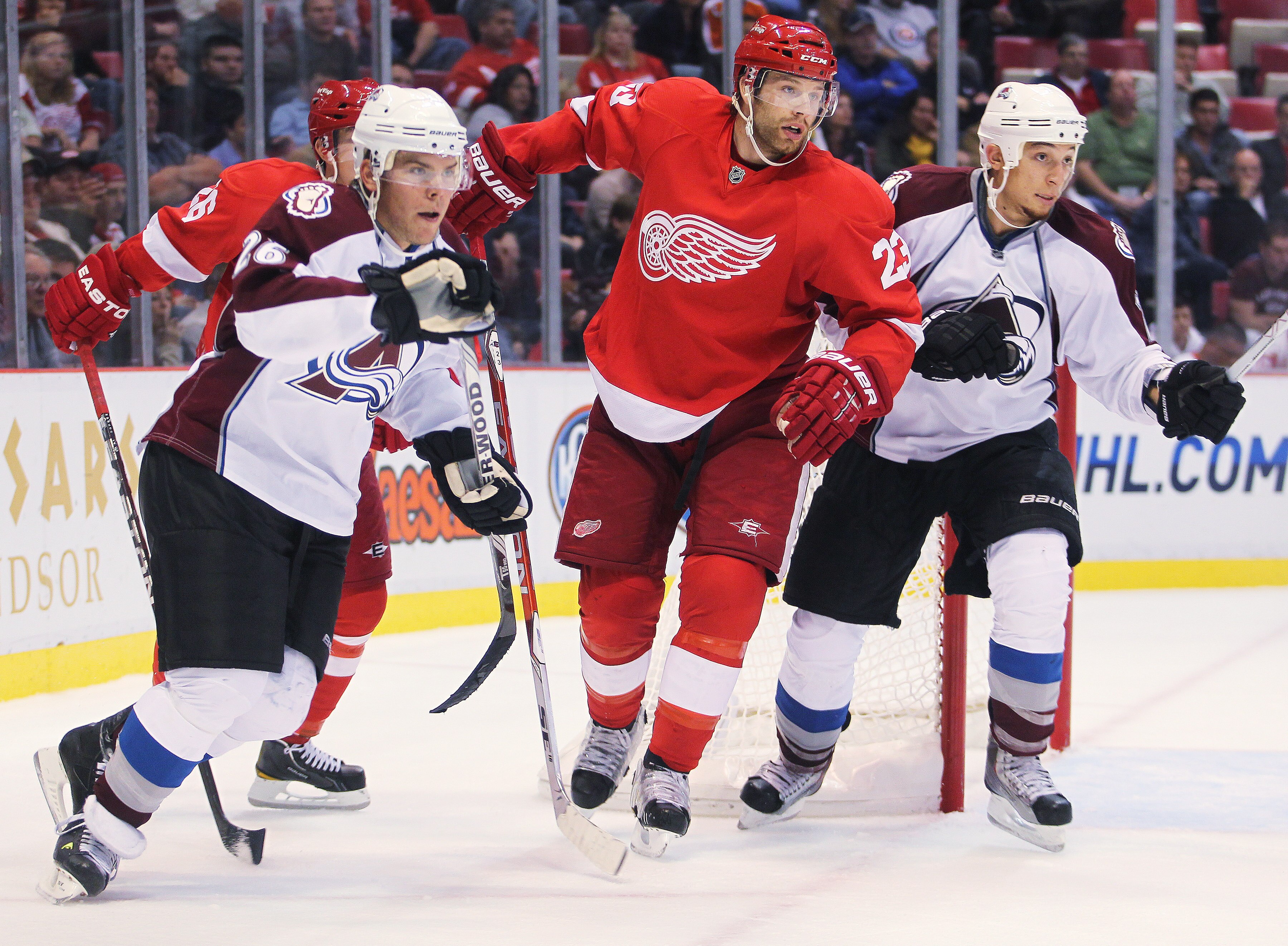 DETROIT - OCTOBER 12:  Brad Stuart #23 of the Detroit Red Wings defends between the Colorado Avalanche pair of Paul Stastny #26 and Chris Stewart #25 in a game on October 12, 2010 at the Joe Louis Arena in Detroit, Michigan. The Avalanche defeated the Red