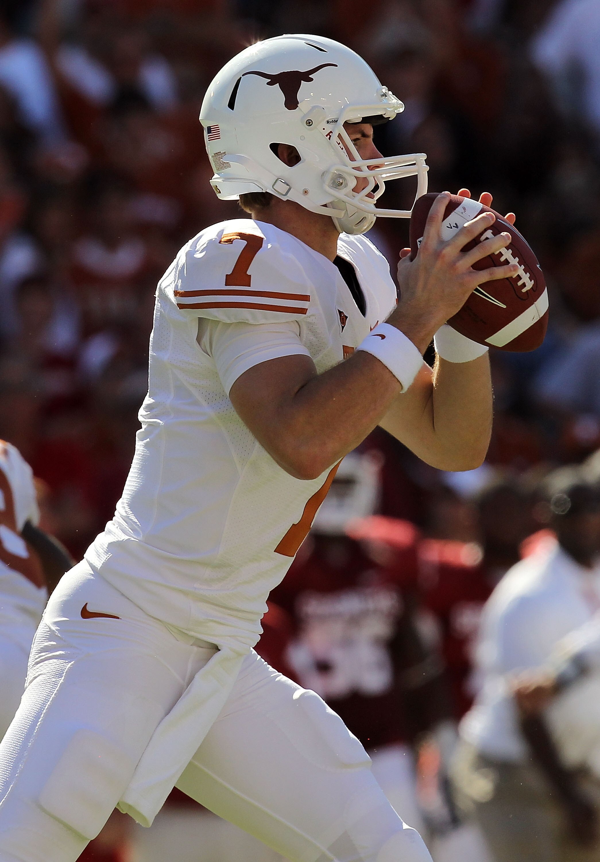DALLAS - OCTOBER 02:  Quarterback Garrett Gilbert #7 of the Texas Longhorns drops back to pass against the Oklahoma Sooners in the second quarter at the Cotton Bowl on October 2, 2010 in Dallas, Texas.  (Photo by Ronald Martinez/Getty Images)