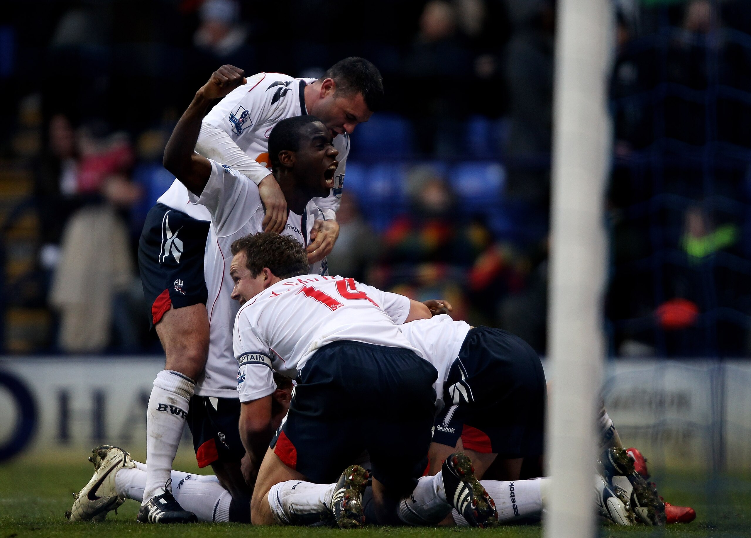 BOLTON, ENGLAND - DECEMBER 12:  Stuart Holden (obscured) of Bolton Wanderers is mobbed by his team mates after scoring the winning goal during the Barclays Premier League match between Bolton Wanderers and Blackburn Rovers at the Reebok Stadium on Decembe