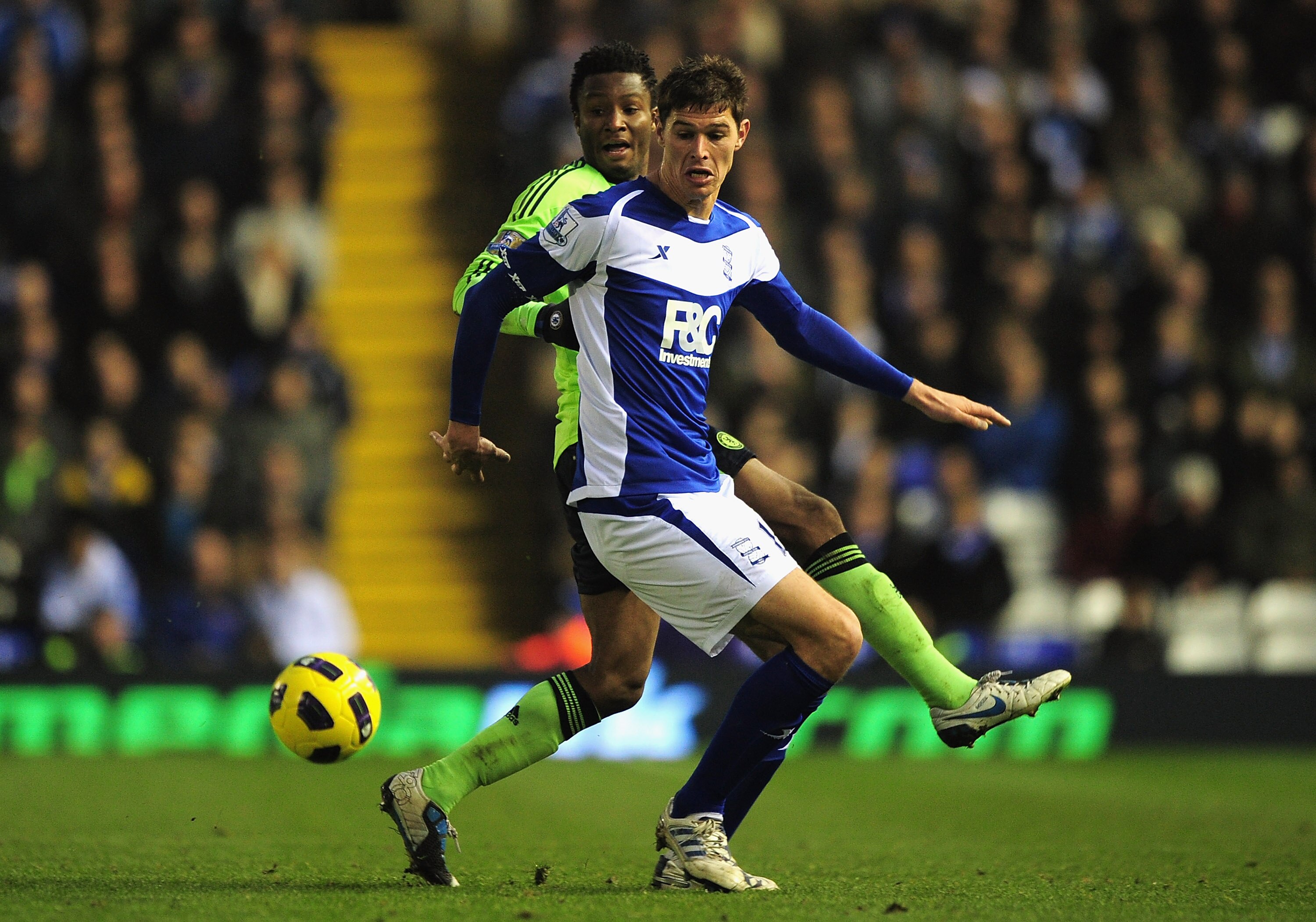 BIRMINGHAM, ENGLAND - NOVEMBER 20:   Nikola Zigic of Birmingham City and John Obi Mikel of Chelsea tussle for the ball during the Barclays Premier League match between Birmingham City and Chelsea at St Andrews on November 20, 2010 in Birmingham, England.