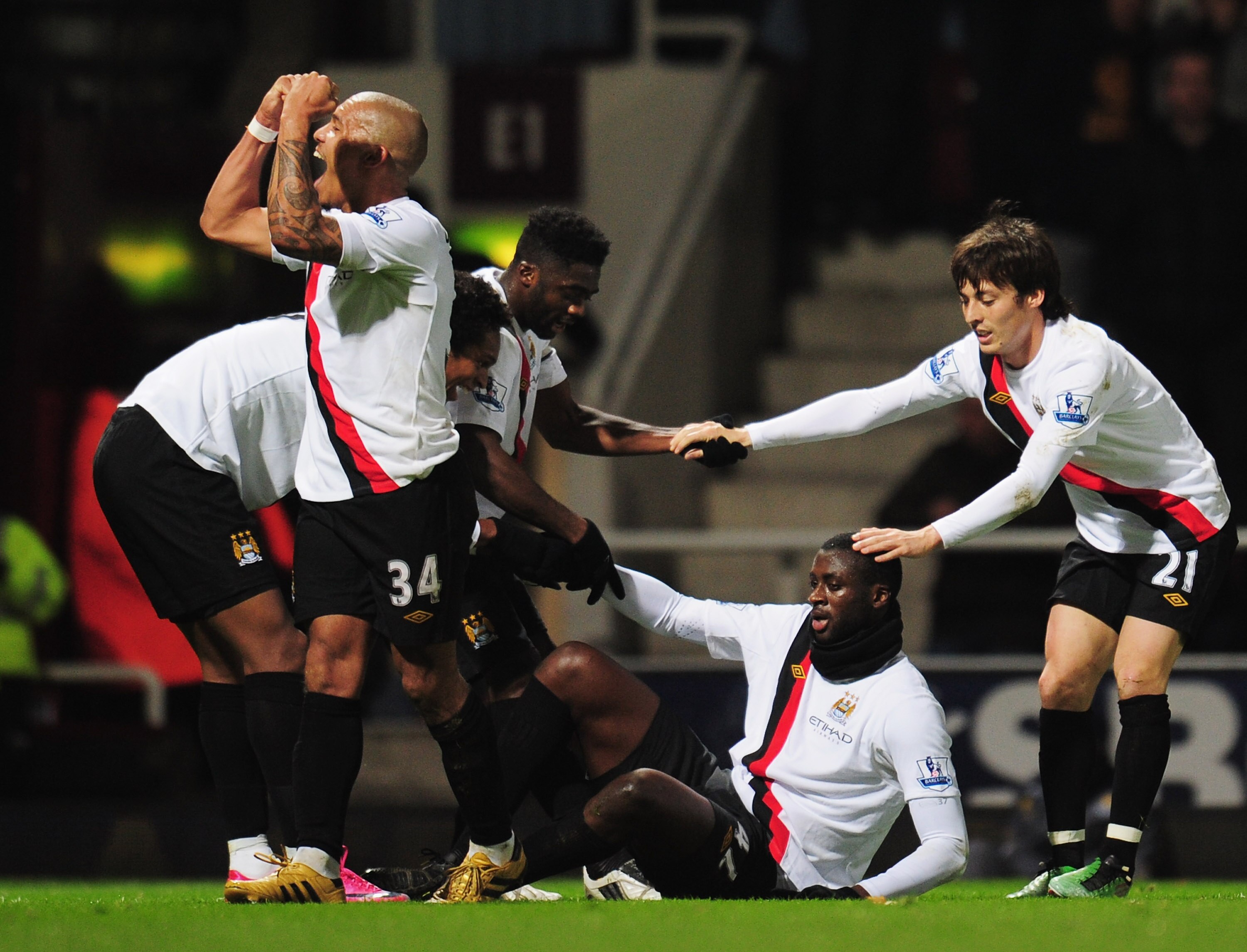 LONDON, UNITED KINGDOM - DECEMBER 11:  Yaya Toure (2nd right) of Manchester City is congratulated by team mates during the Barclays Premier League match between West Ham United and Manchester City at Upton Park on December 11, 2010 in London, England.  (P
