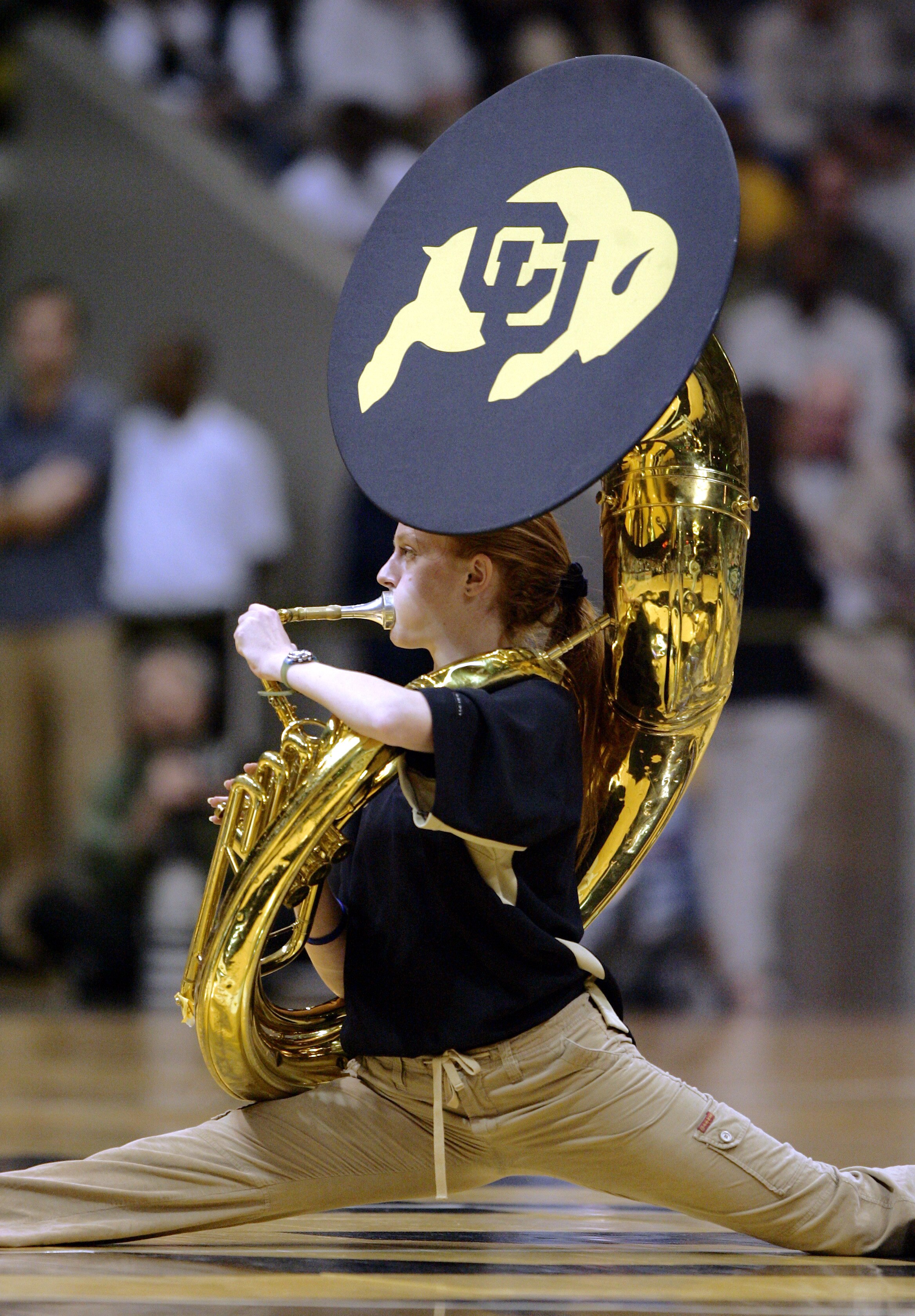 BOULDER, CO - JANUARY 26:  A member of the Colorado Buffaloes marching band does a tuba split during a timeout against the Missouri Tigers in the second half on January 26, 2005 at the Coors Event Center in Boulder, Colorado. Colorado won the game 64-62.