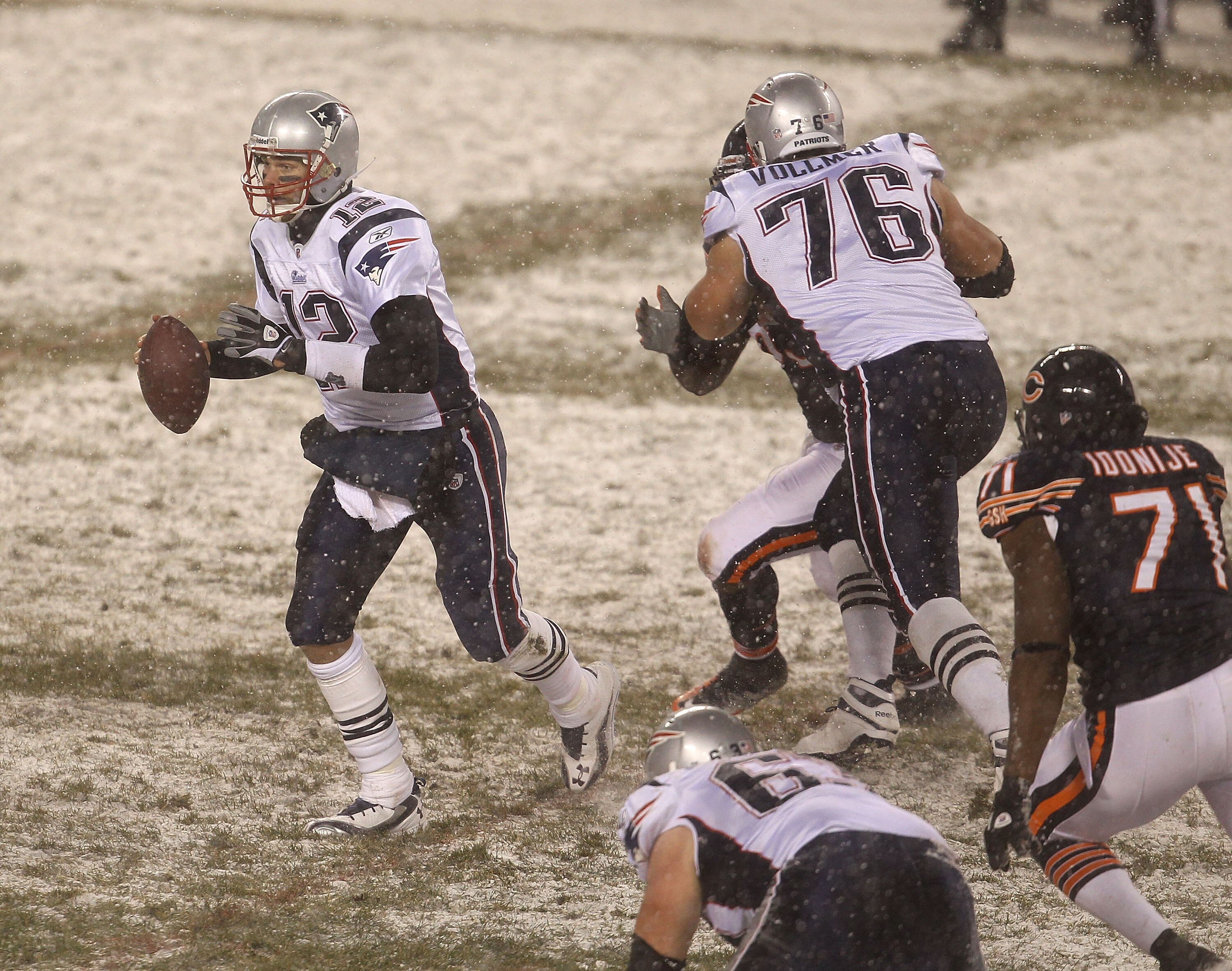 CHICAGO, IL - DECEMBER 12: Tom Brady #12 of the New England Patriots moves to avoid Israel Idonije #71 of the Chicago Bears as he looks for a receiver at Soldier Field on December 12, 2010 in Chicago, Illinois. The Patriots defeated the Bears 36-7. (Photo
