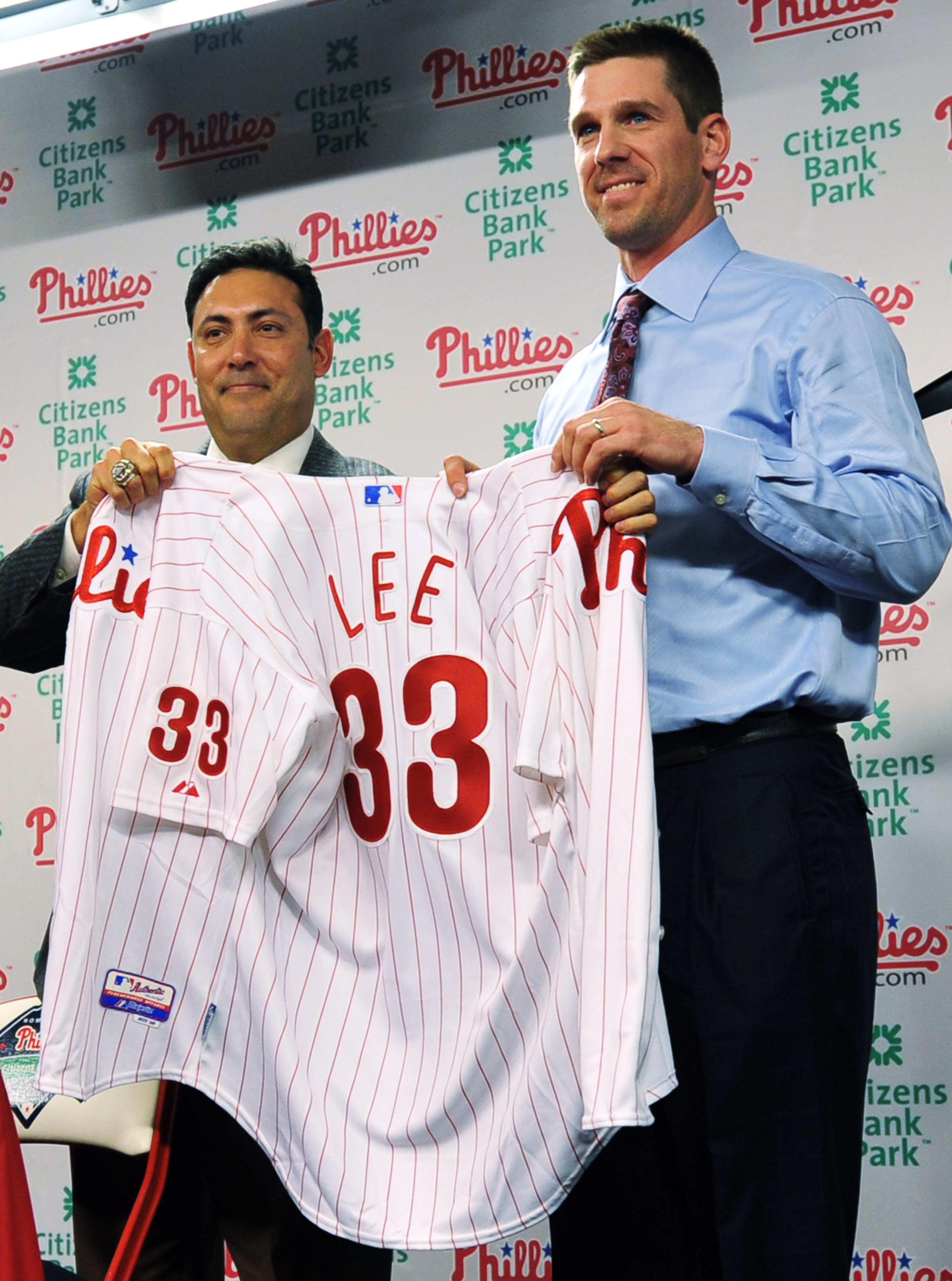 PHILADELPHIA - DECEMBER 15: Pitcher Cliff Lee (R) #33 of the Philadelphia Phillies is introduced to the media and presented his jersey by the Philadelphia Phillies general manager Ruben Amaro Jr. during a press conference at Citizens Bank Park on Decembe PHILADELPHIA - DECEMBER 15: Pitcher Cliff Lee (R) #33 of the Philadelphia Phillies is introduced to the media and presented his jersey by the Philadelphia Phillies general manager Ruben Amaro Jr. during a press conference at Citizens Bank Park on Decembe