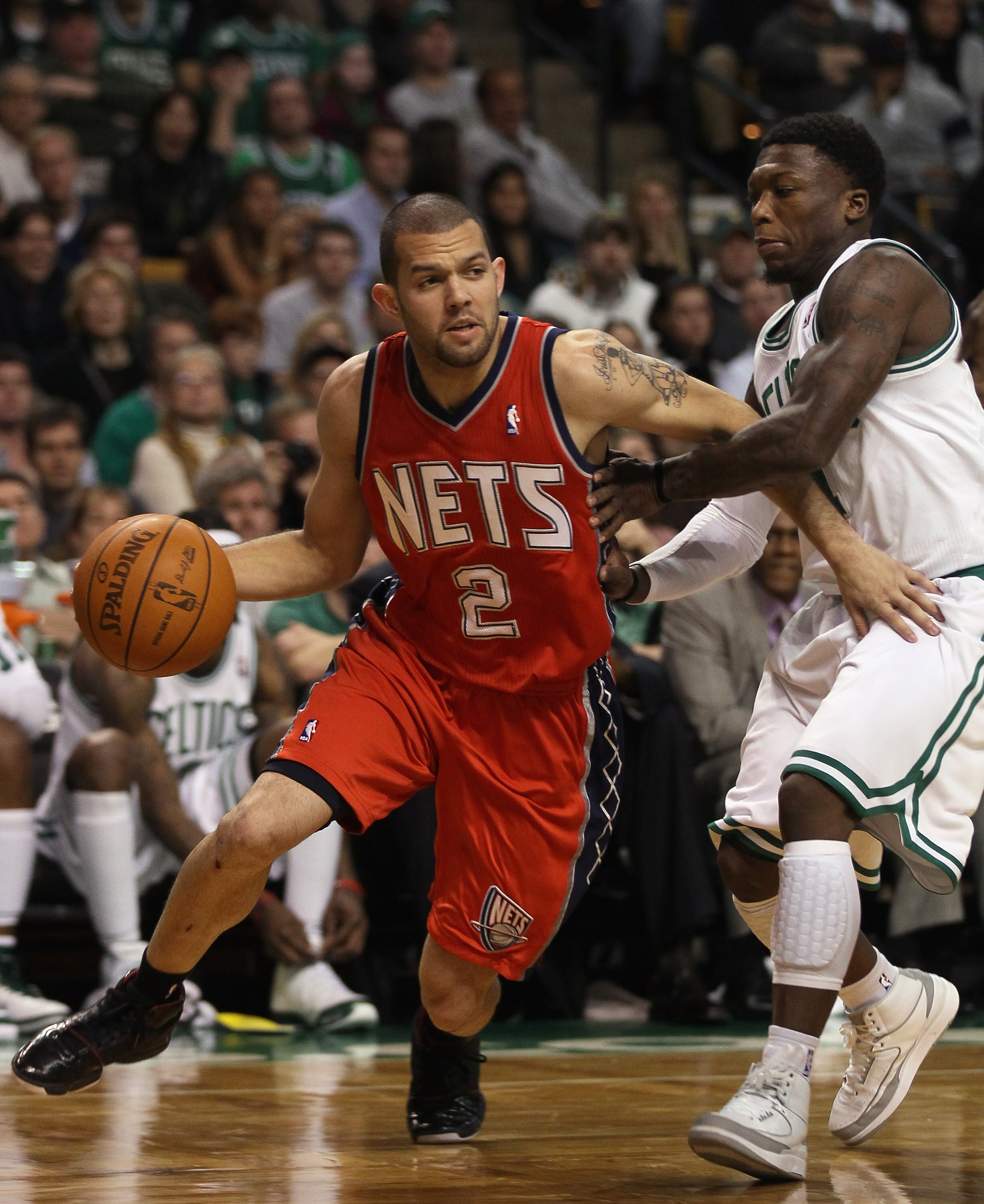 BOSTON - NOVEMBER 24:  Jordan Farmar #2 of the New Jersey Nets drives around Nate Robinson #4 of the Boston Celitcs on November 24, 2010 at the TD Garden in Boston, Massachusetts. The Celtics defeated the nets 89-83. NOTE TO USER: User expressly acknowled