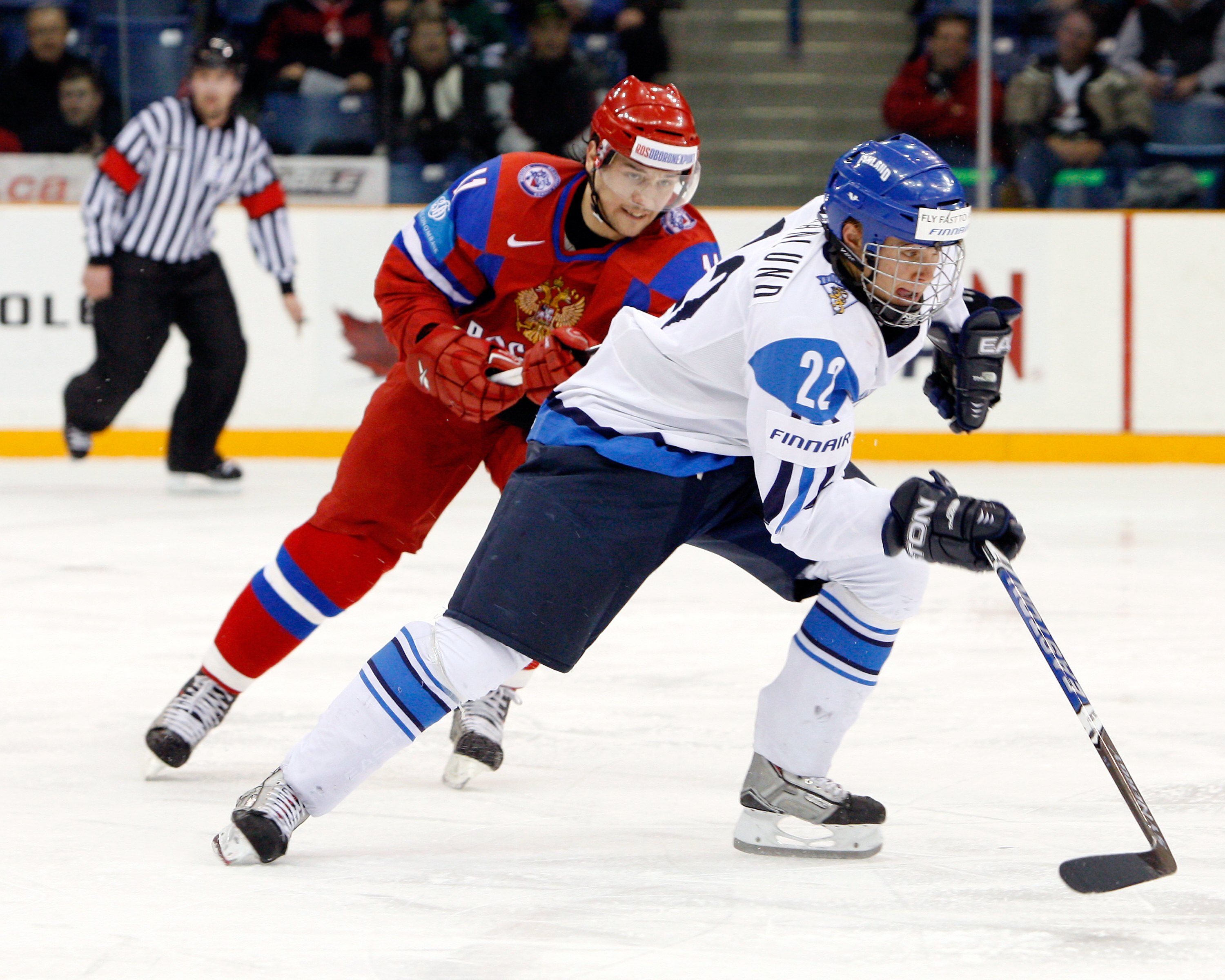 SASKATOON, SK - JANUARY 4:  Mikael Granlund #22 of Team Finland and Maxim Trunev #11 of Team Russia skate during the 2010 IIHF World Junior Championship Tournament Fifth Place game on January 4, 2010 at the Credit Union Centre in Saskatoon, Saskatchewan,