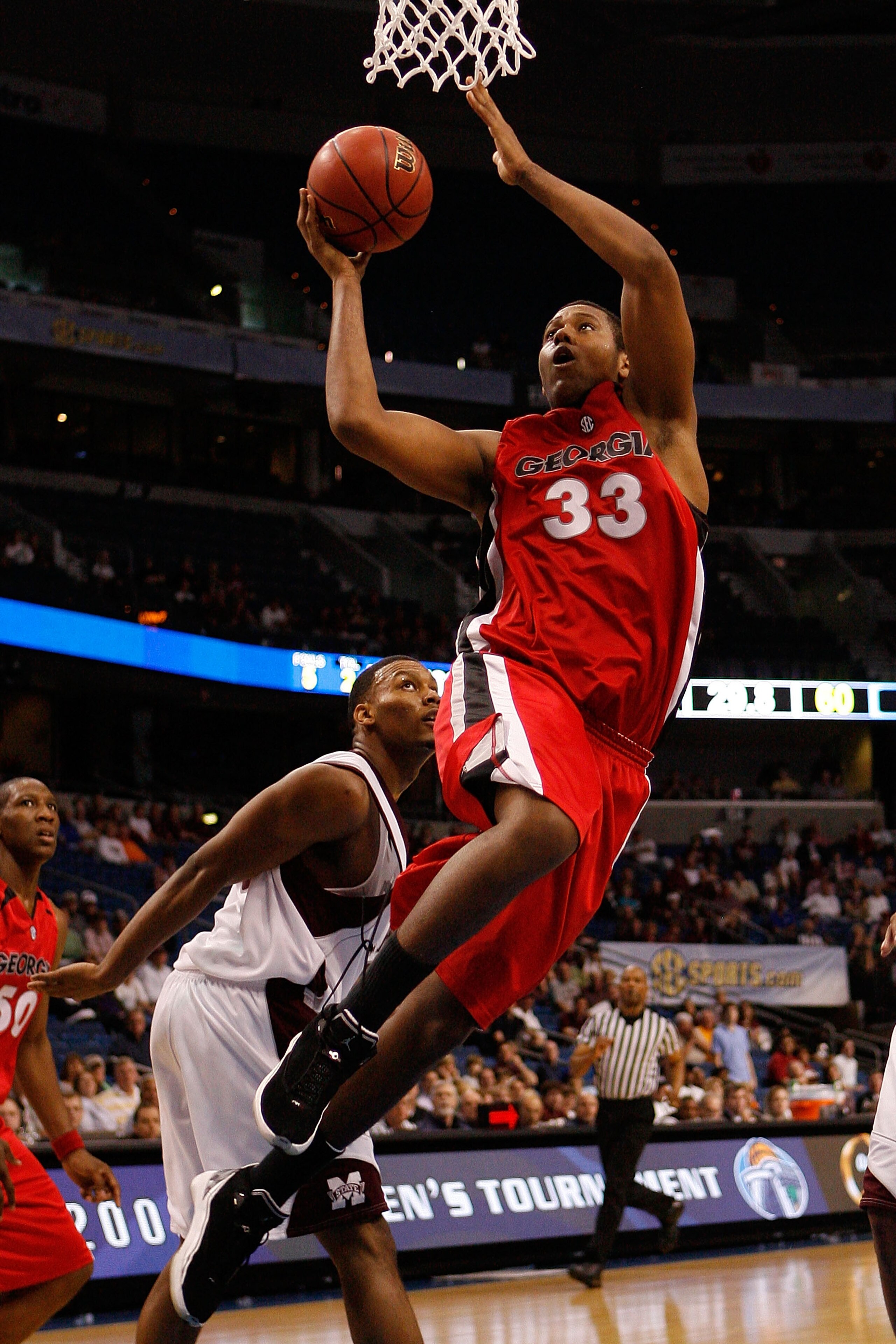 TAMPA, FL - MARCH 12:  Trey Thompkins #33 of the Georgia Bulldogs makes a shot over Romero Osby #5 of the Mississippi State Bulldogs during the first round of the SEC Men's Basketball Tournament on March 12, 2009 at The St. Pete Times Forum in Tampa, Flor