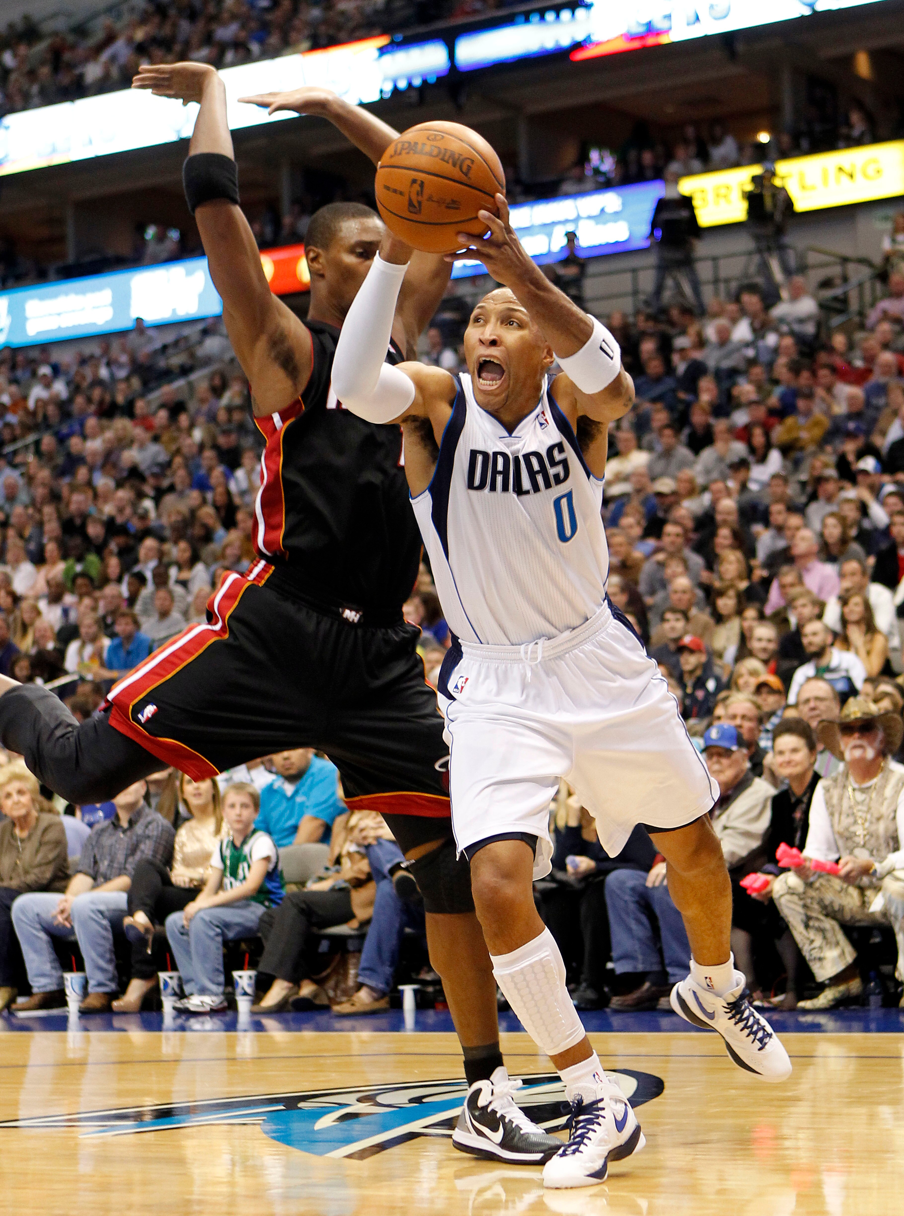 DALLAS - NOVEMBER 27: Shawn Marion #0 of the Dallas Mavericks drives by Chris Bosh #1 of the Miami Heat on November 27, 2010 at the American Airlines Center in Dallas, Texas. NOTE TO USER: User expressly acknowledges and agrees that, by downloading and or