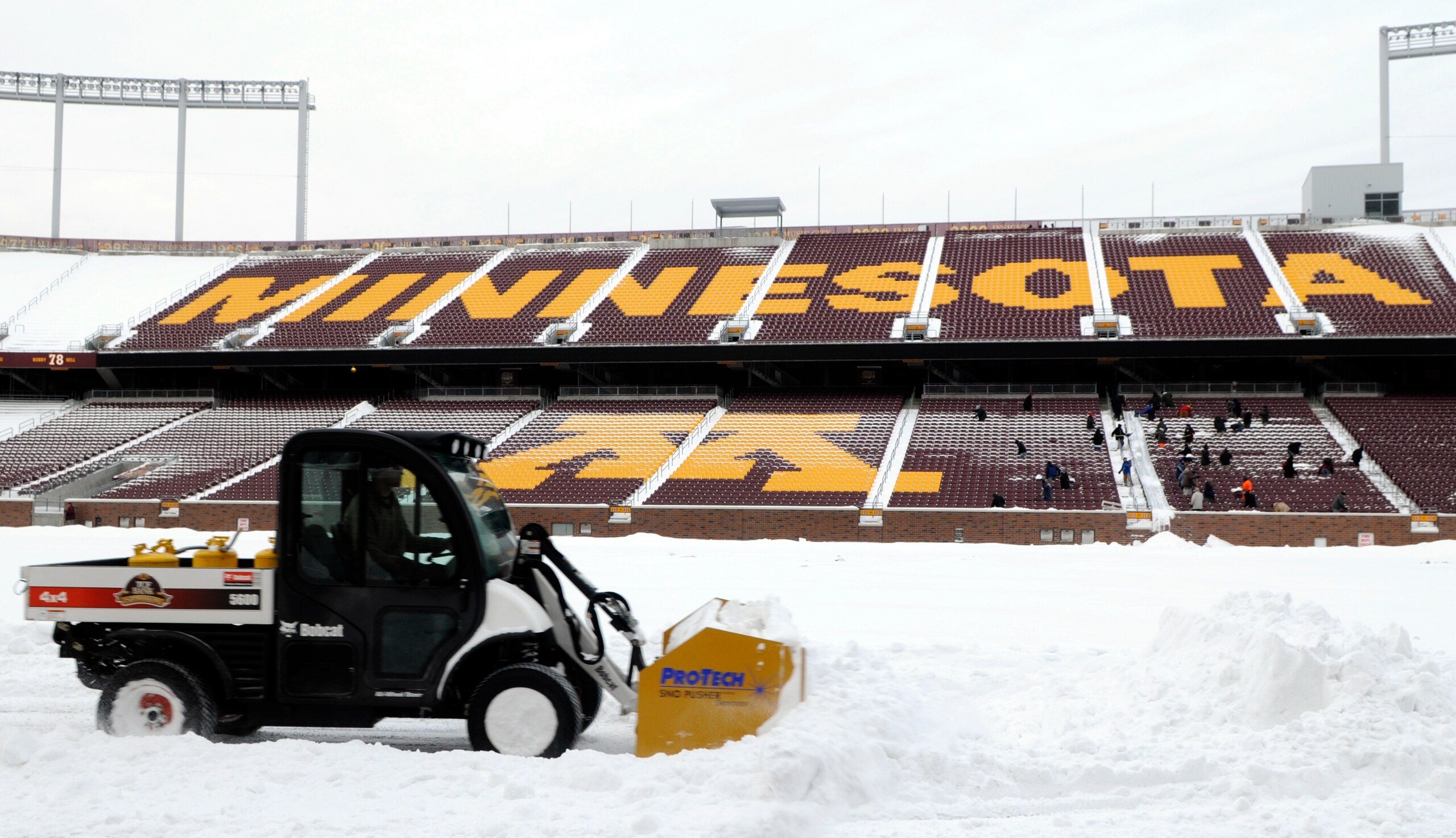 MINNEAPOLIS, MN - DECEMBER 15: Heavy machinery moves snow on the field as TCF Bank Stadium prepares for a potential monday night football game between the Minnesota Vikings and Chicago Bears on December 15, 2010 in Minneapolis, Minnesota. Preparations are